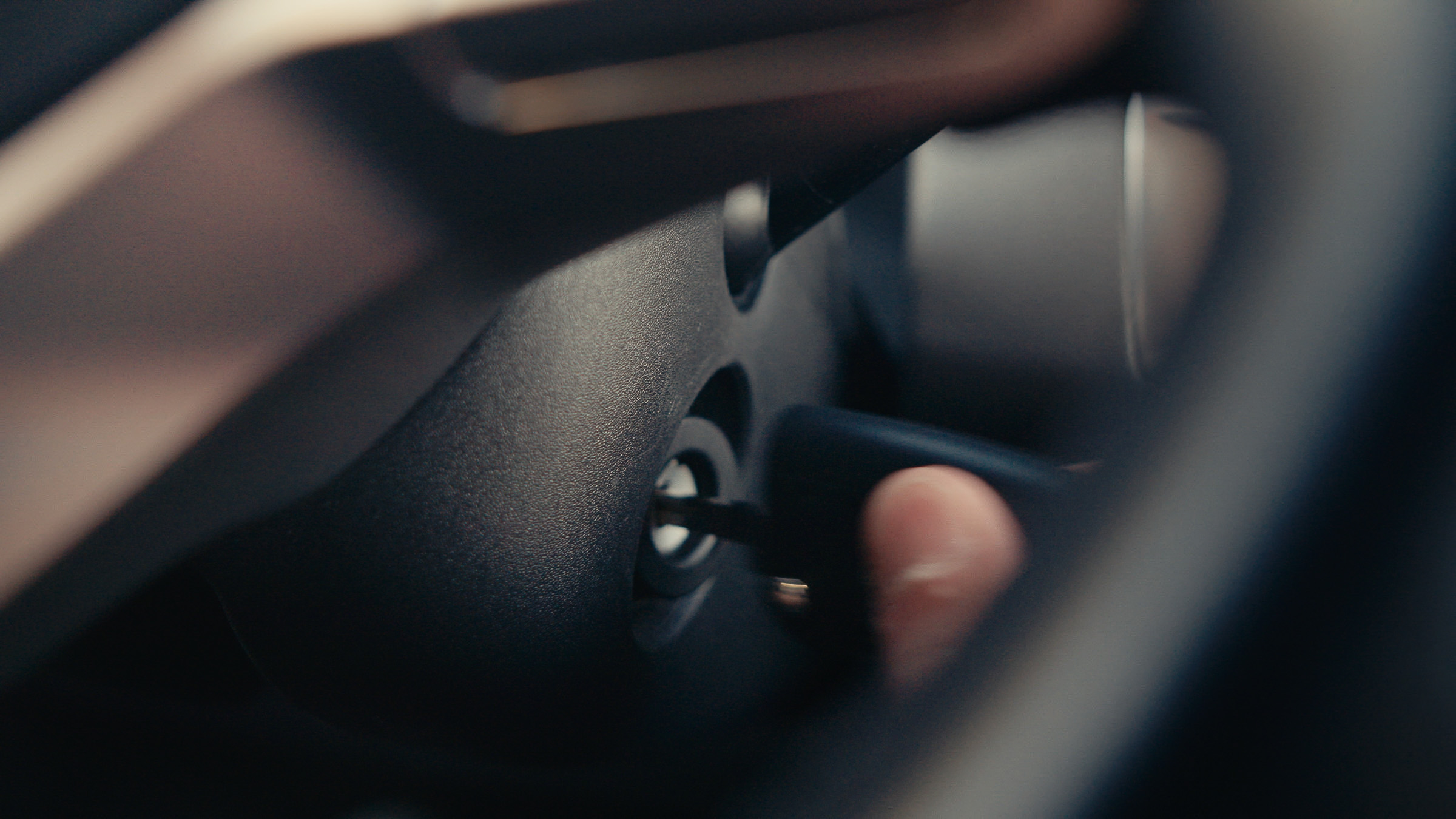 Hand turning the ignition key inside a camper van