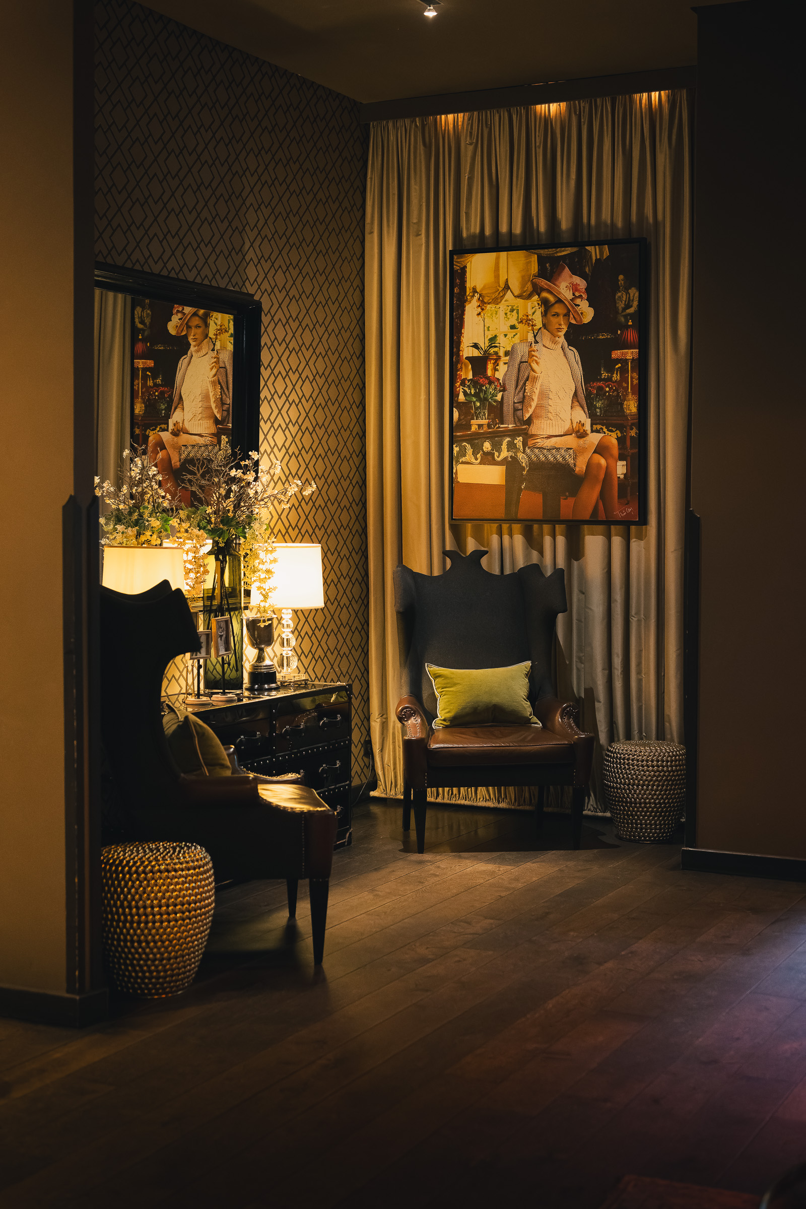 Artwork and a tall mirror in a softly lit hallway at The George