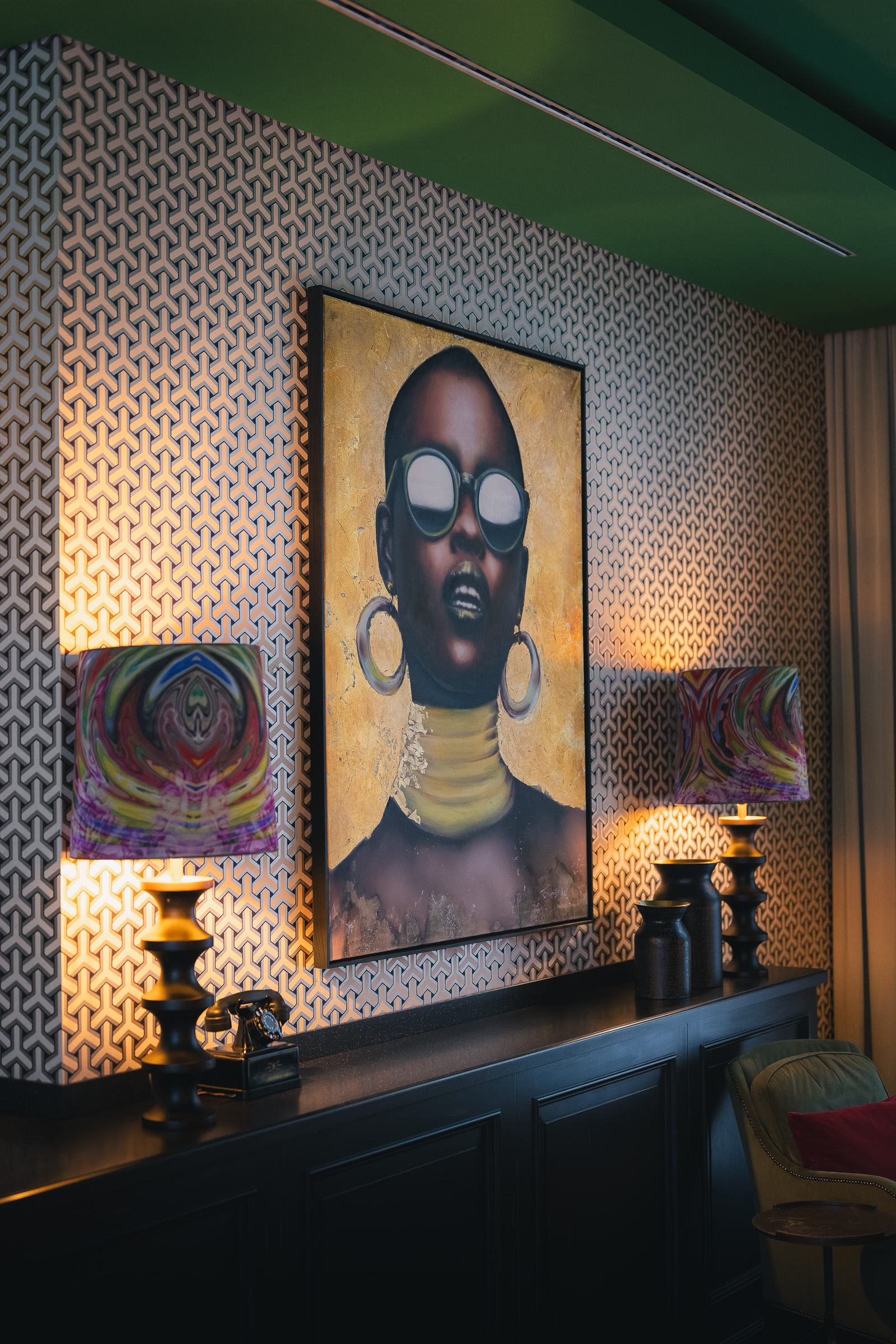 Large portrait displayed above a console table in the hotel interior