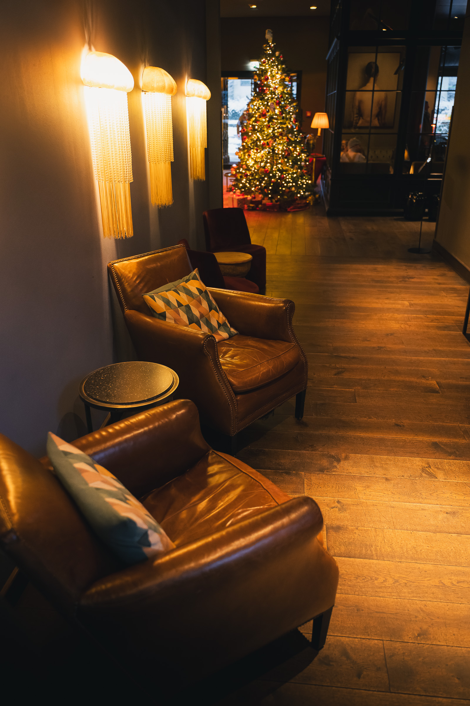 Leather armchairs in a warm hotel corridor decorated for Christmas