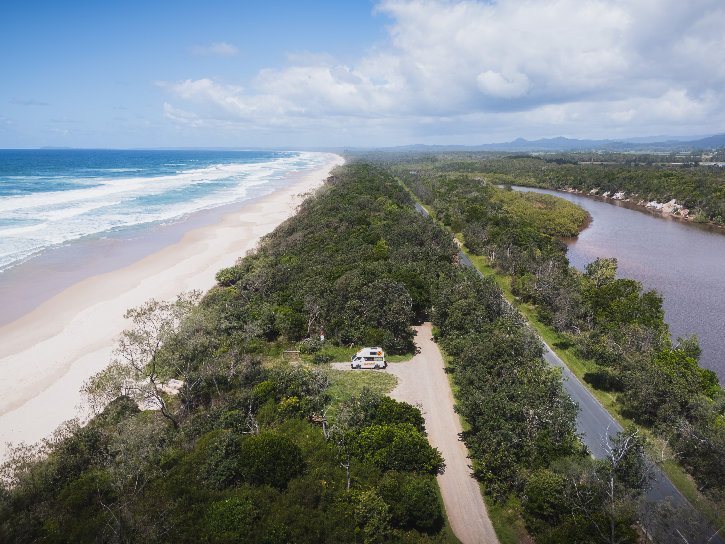 Aerial view of a coastal road between the Pacific beach and a river