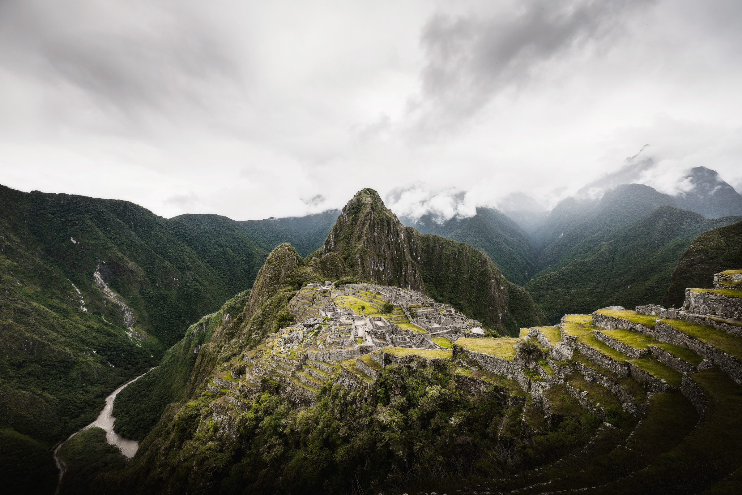 Aerial view of Machu Picchu surrounded by green Andean peaks