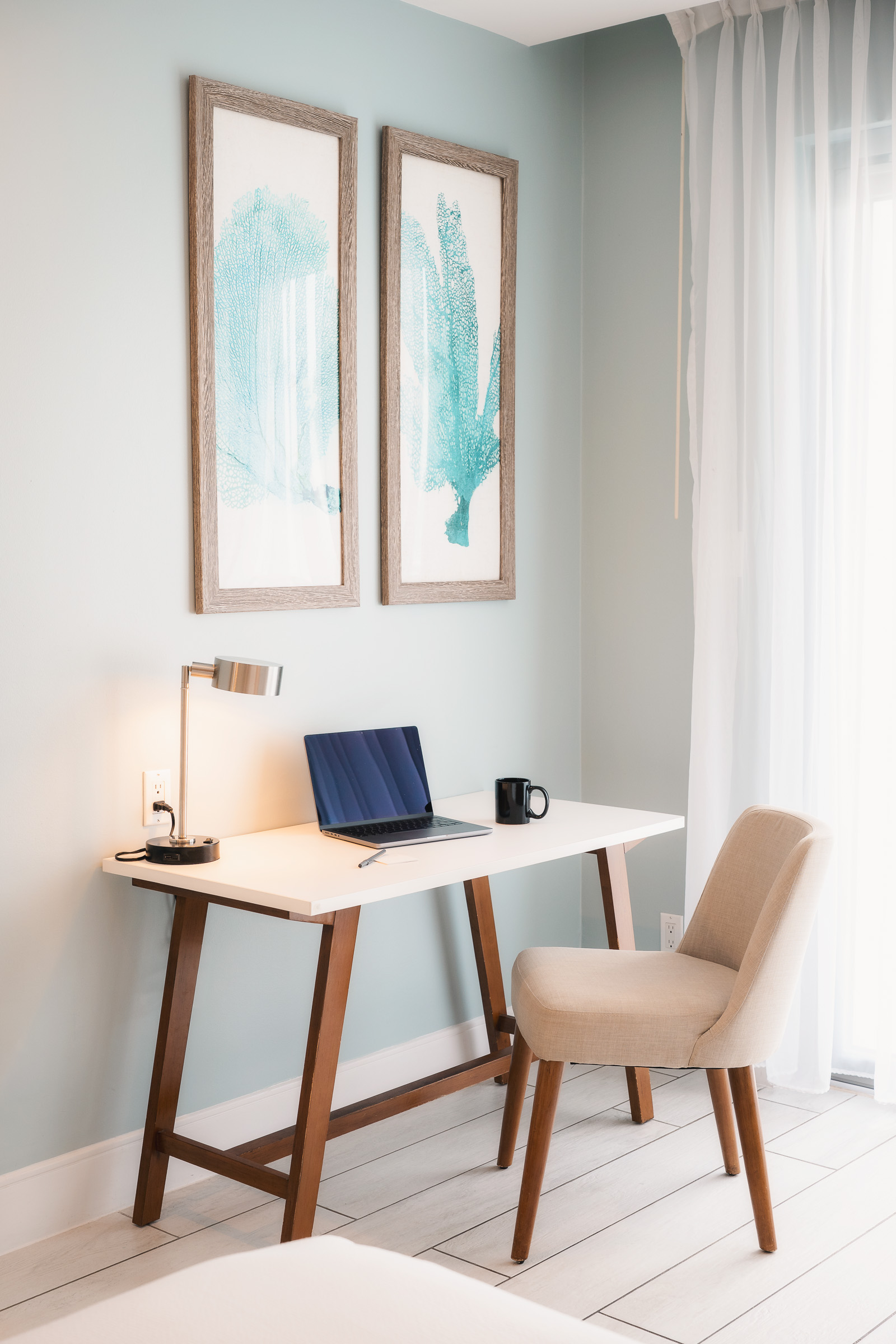 Work desk beside a sunlit window in a Courtyard Aruba guest room