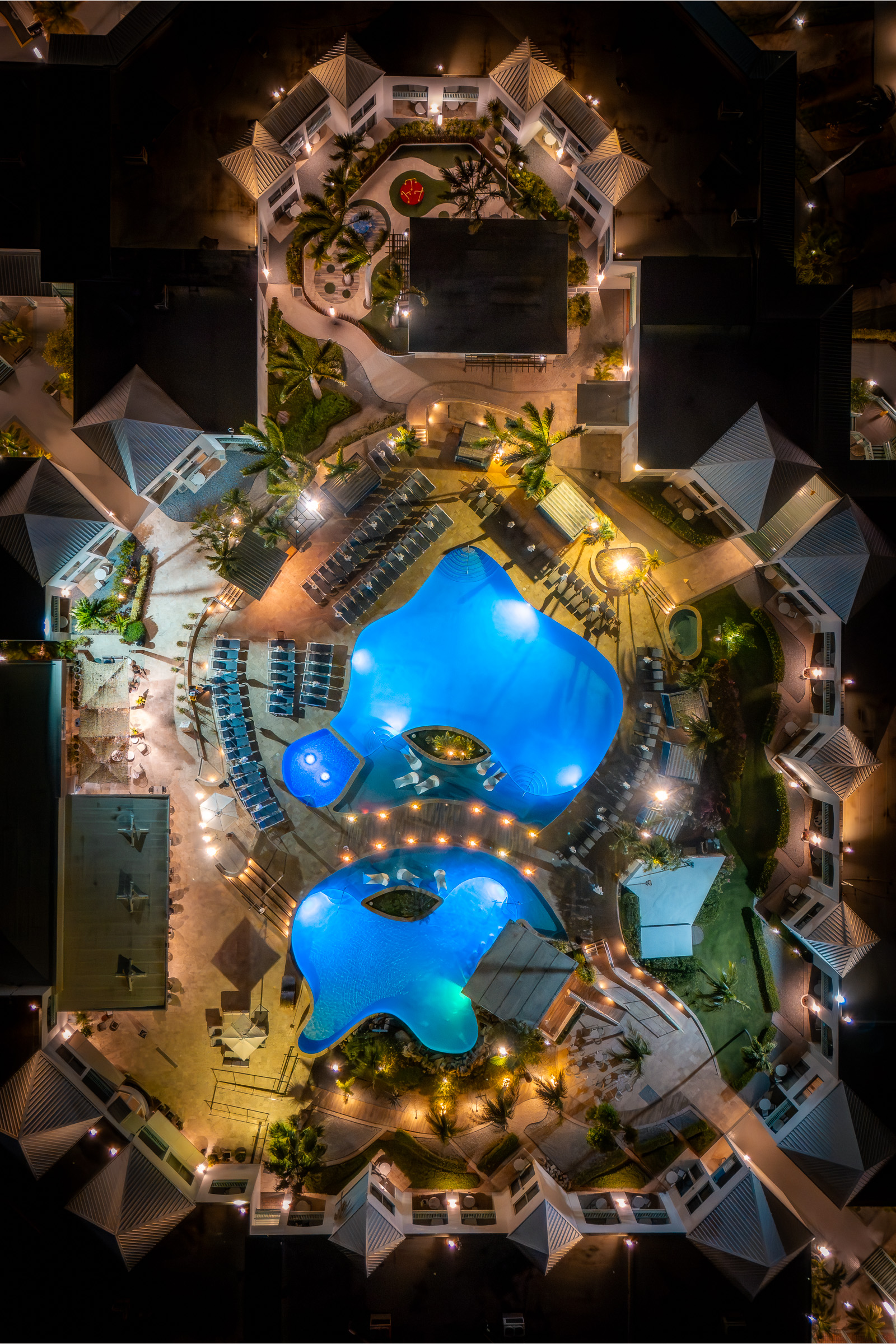 Top-down aerial view of the illuminated Courtyard Aruba resort at night