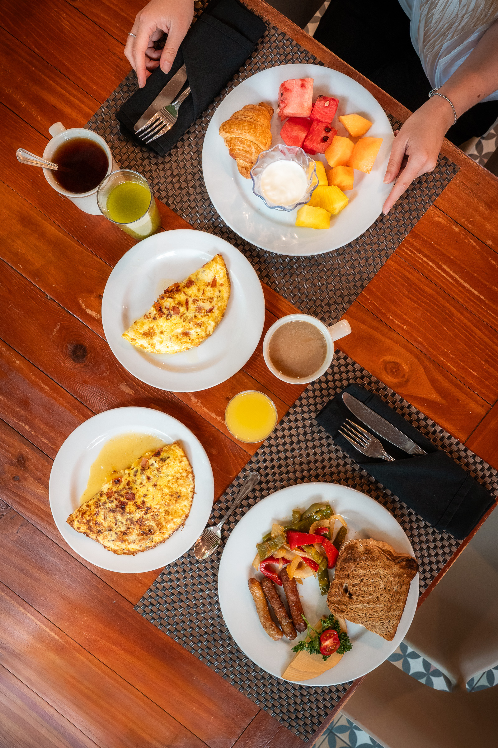 Overhead view of a shared breakfast spread at Courtyard Aruba
