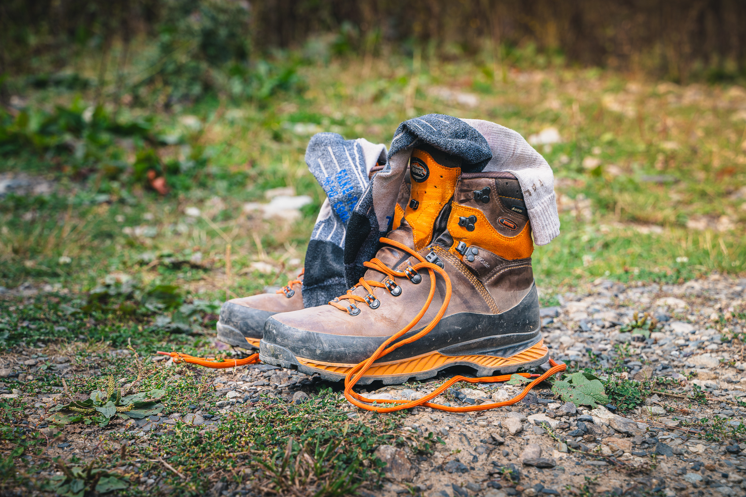 Paar Wanderschuhe mit orangefarbenen Schnürsenkeln am Ausgangspunkt