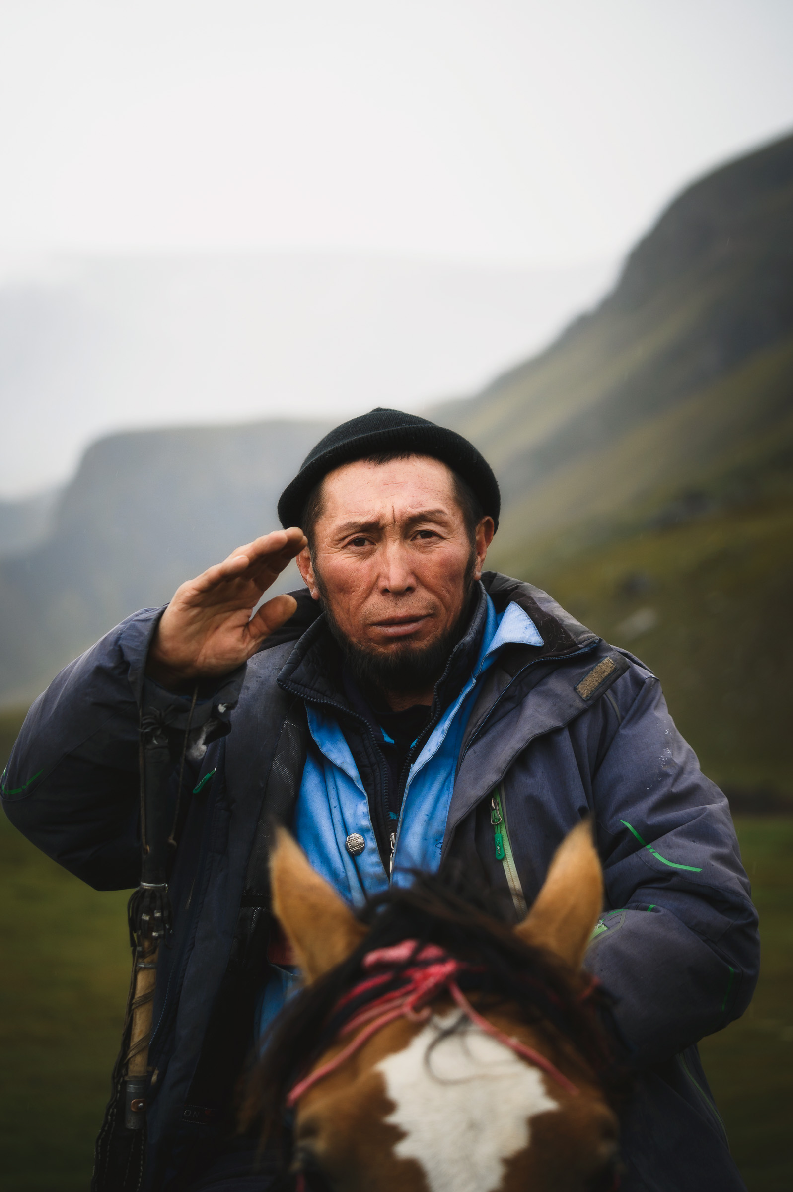Portrait of a horseman in a green mountain valley