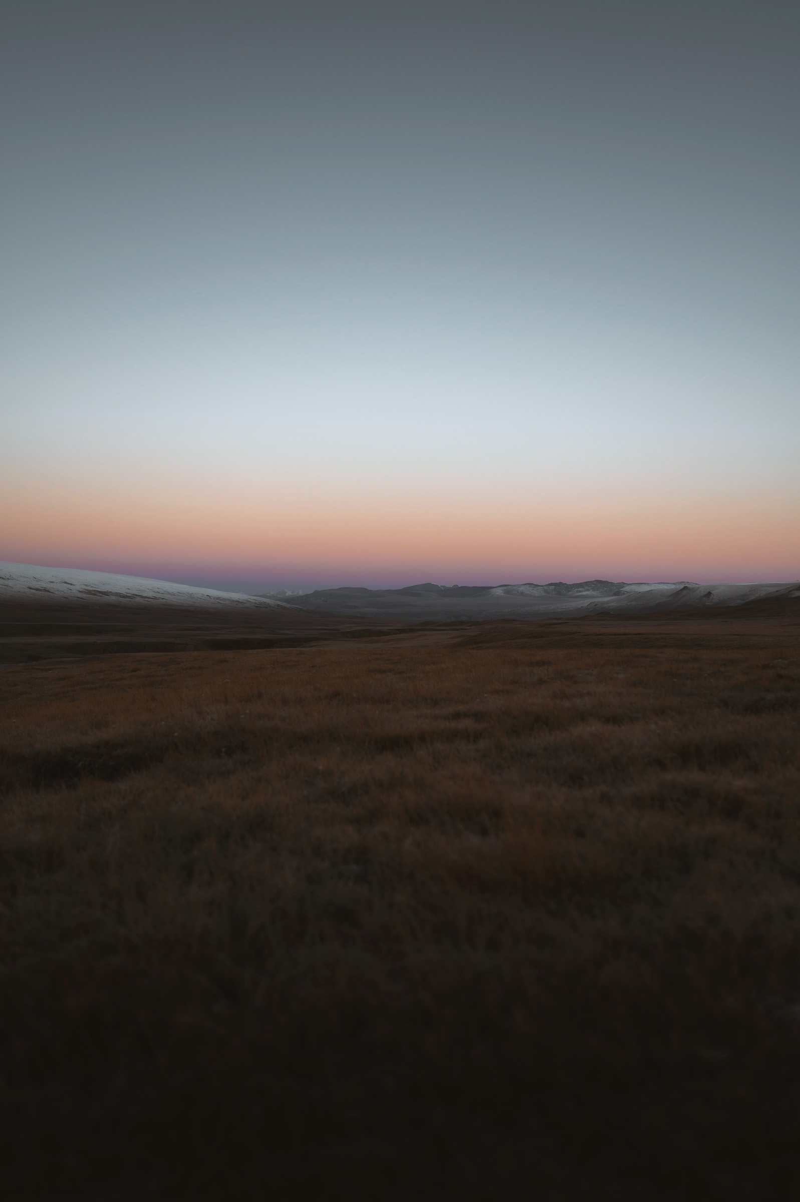 Twilight colors stretching across a distant highland plain