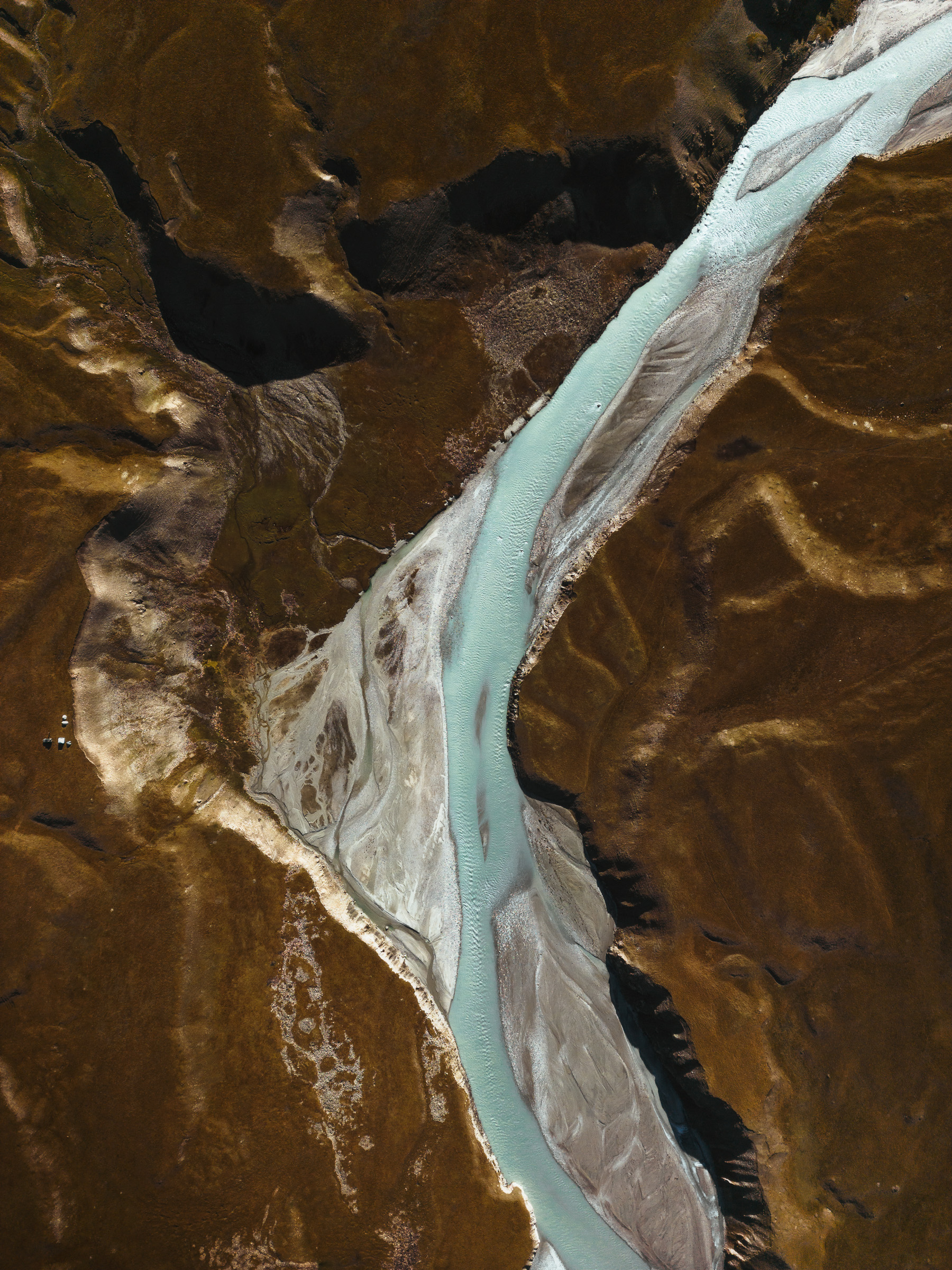Top-down view of a turquoise glacial river