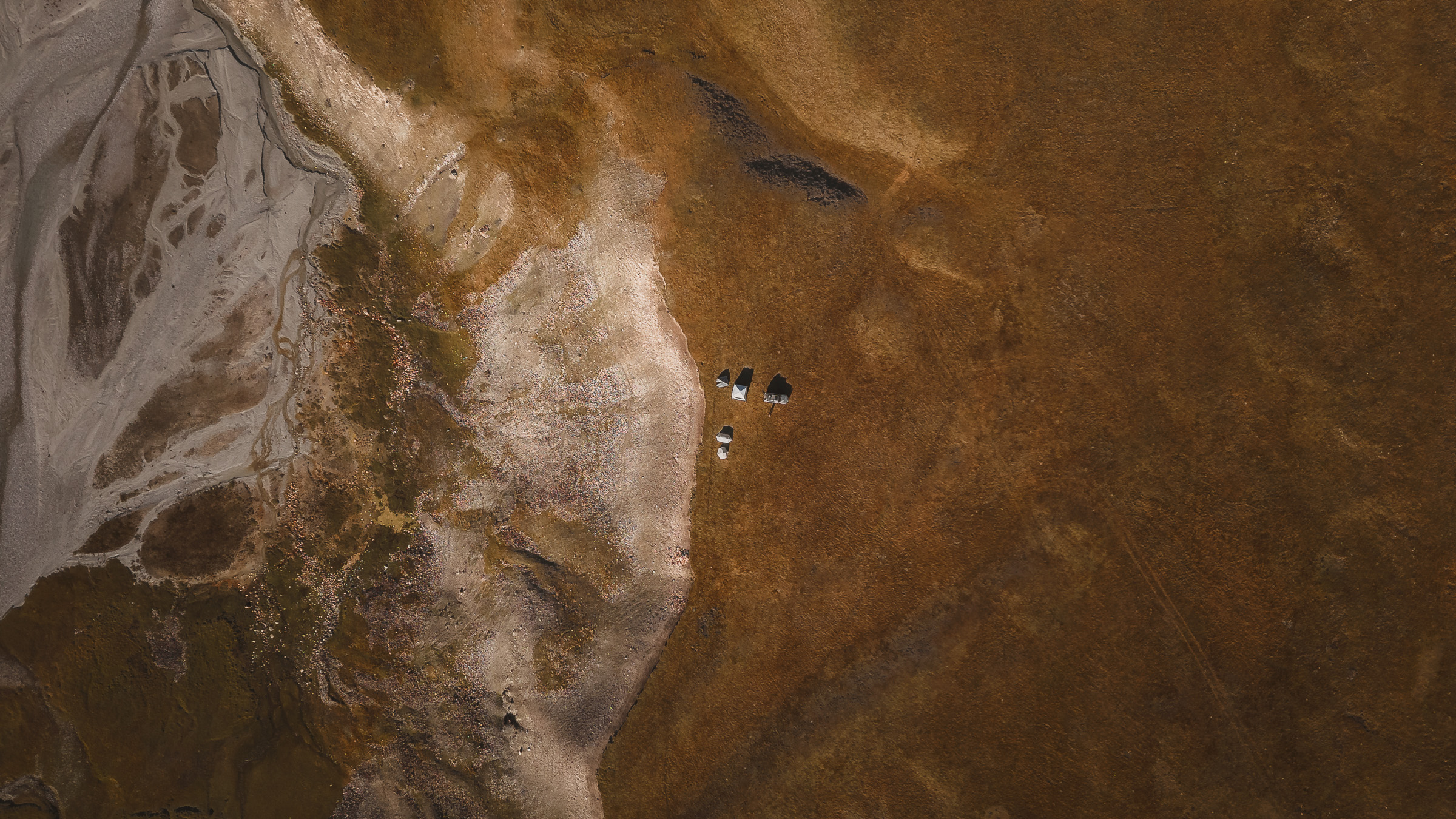 Aerial view of tents on patterned highland terrain