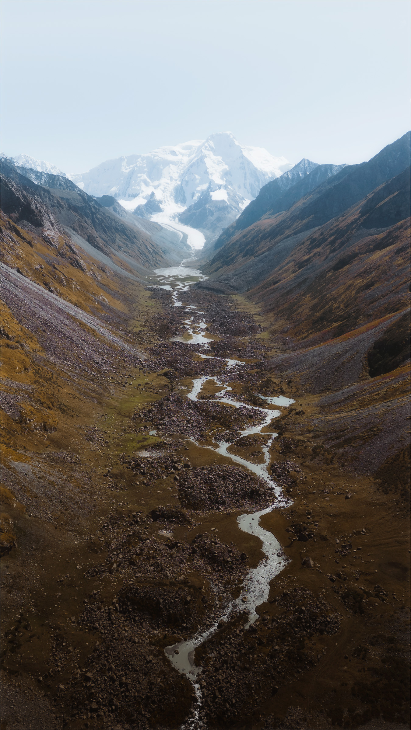 Mountain stream winding through a steep alpine valley
