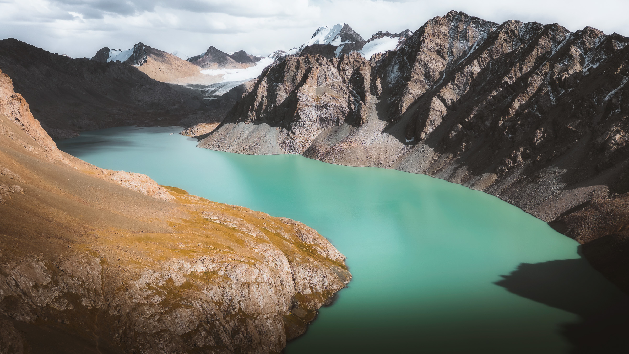 Turquoise alpine lake encircled by rugged peaks
