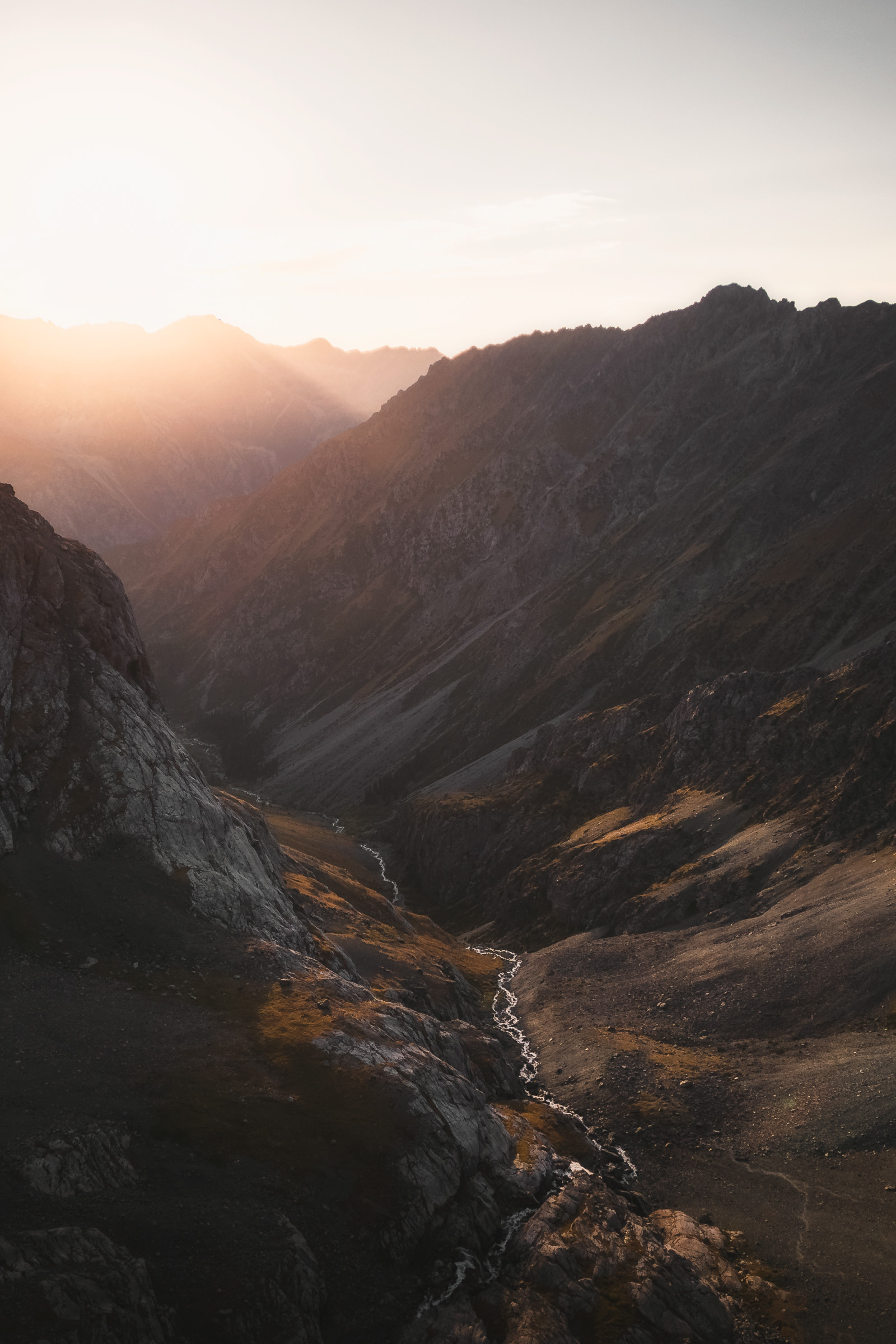 Sunset shining into a deep rugged mountain valley