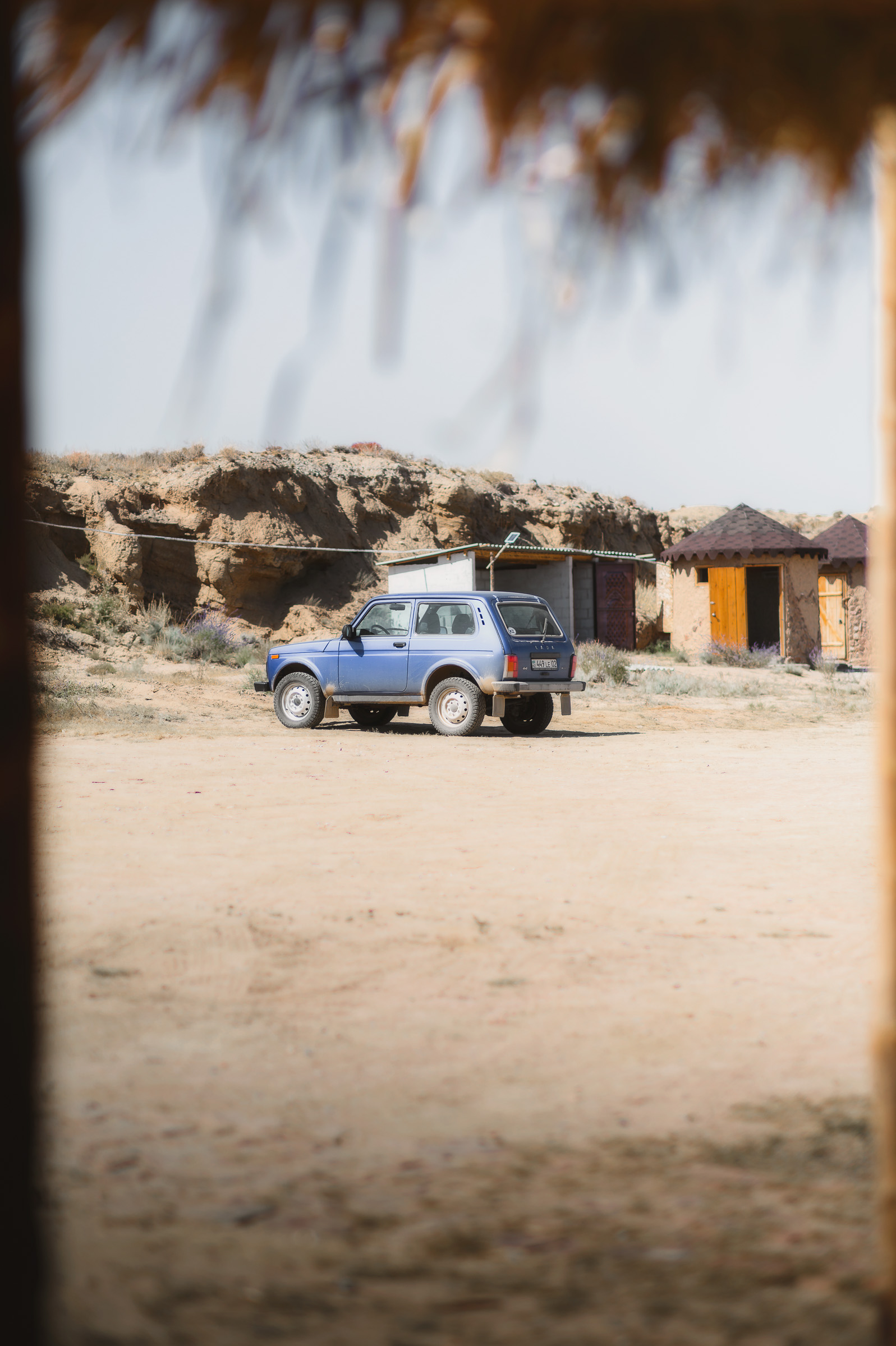 Off-road vehicle beside a remote roadside settlement