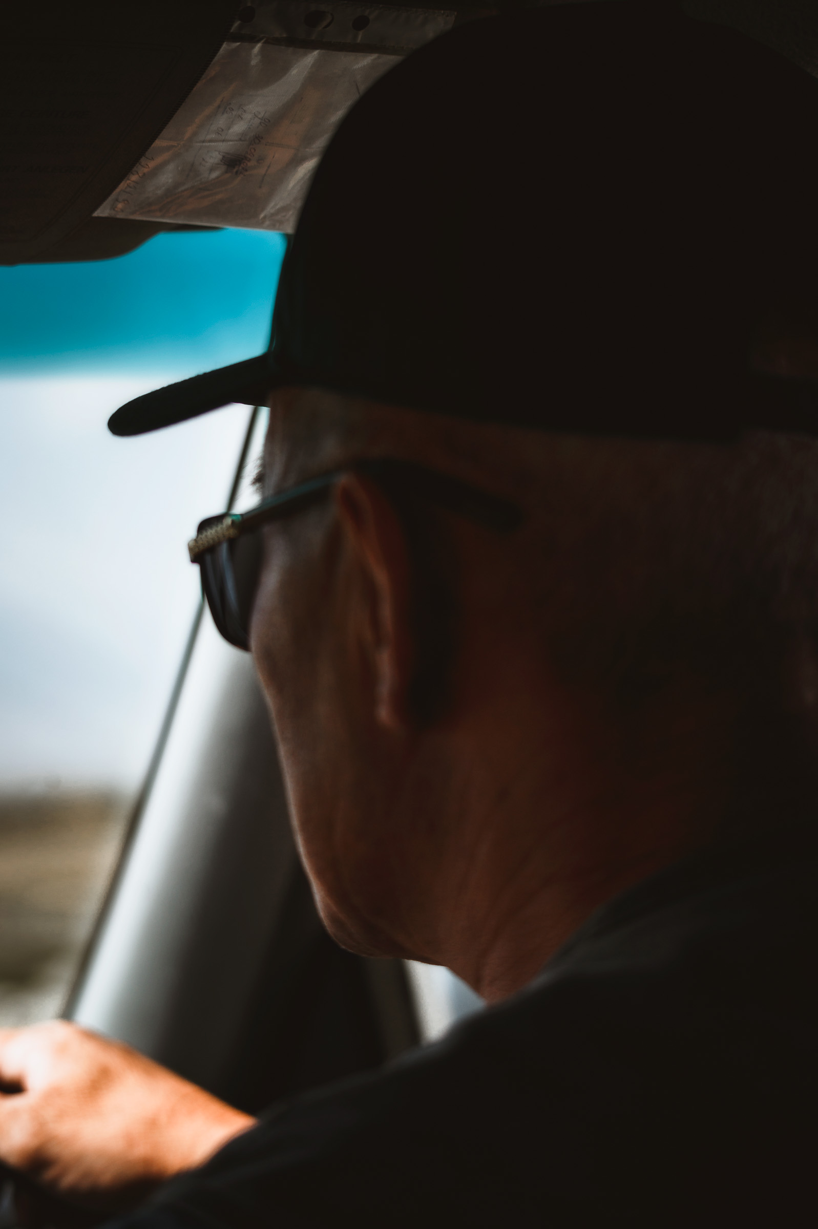 Driver in a cap watching the road through the windshield
