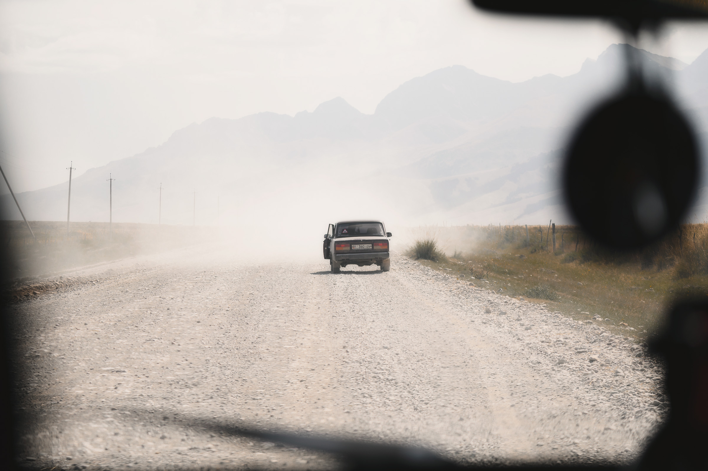 Off-road vehicle traveling along a dusty rural road