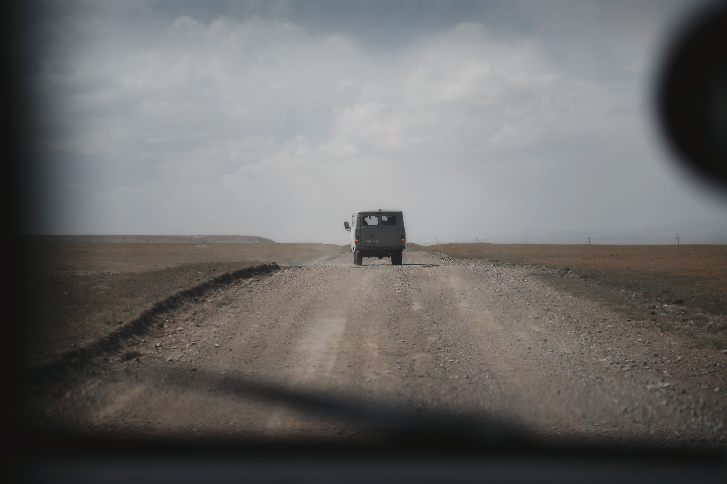 Off-road vehicle driving toward an approaching storm