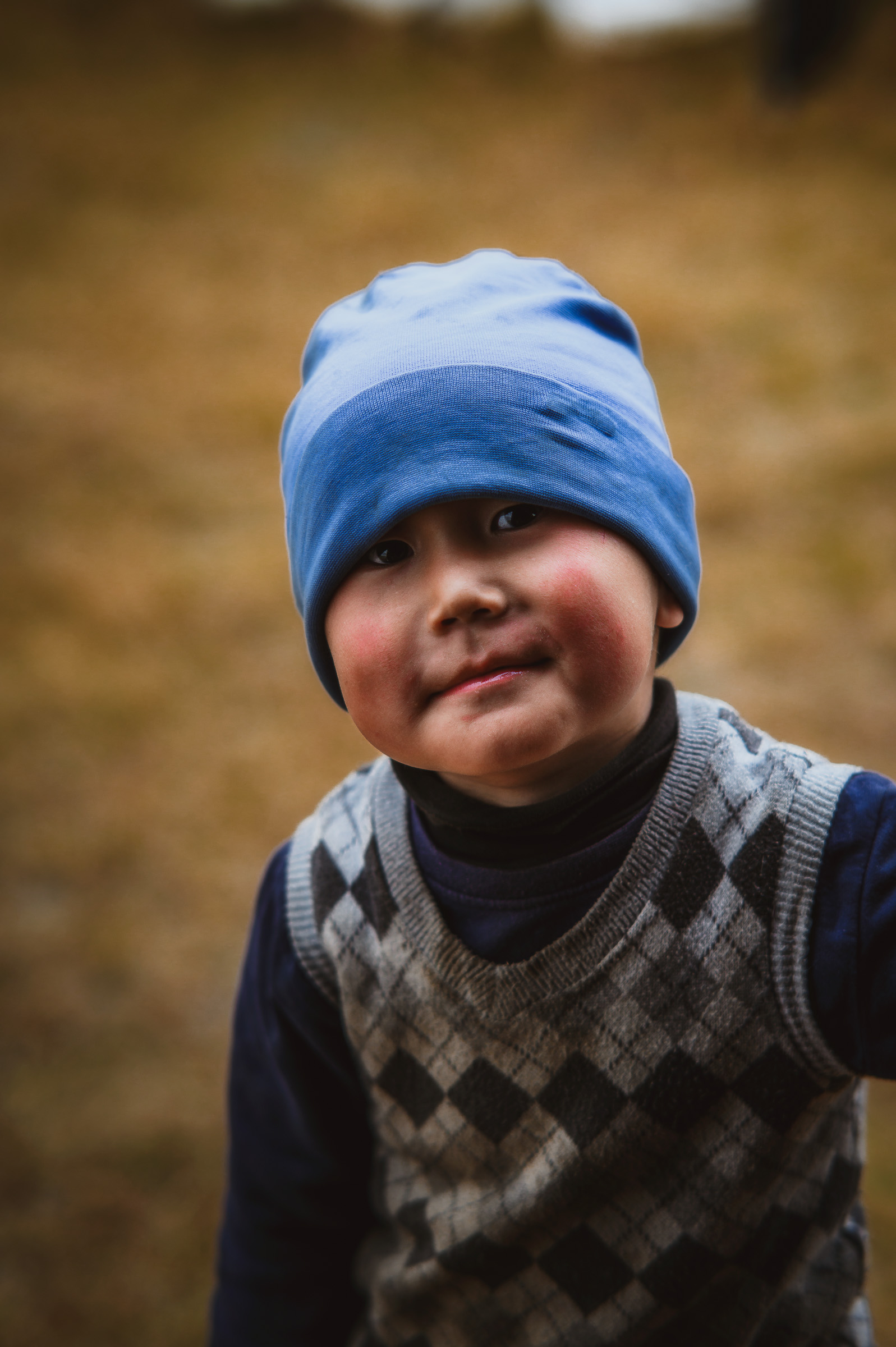 Portrait of a young child wearing a blue knit hat