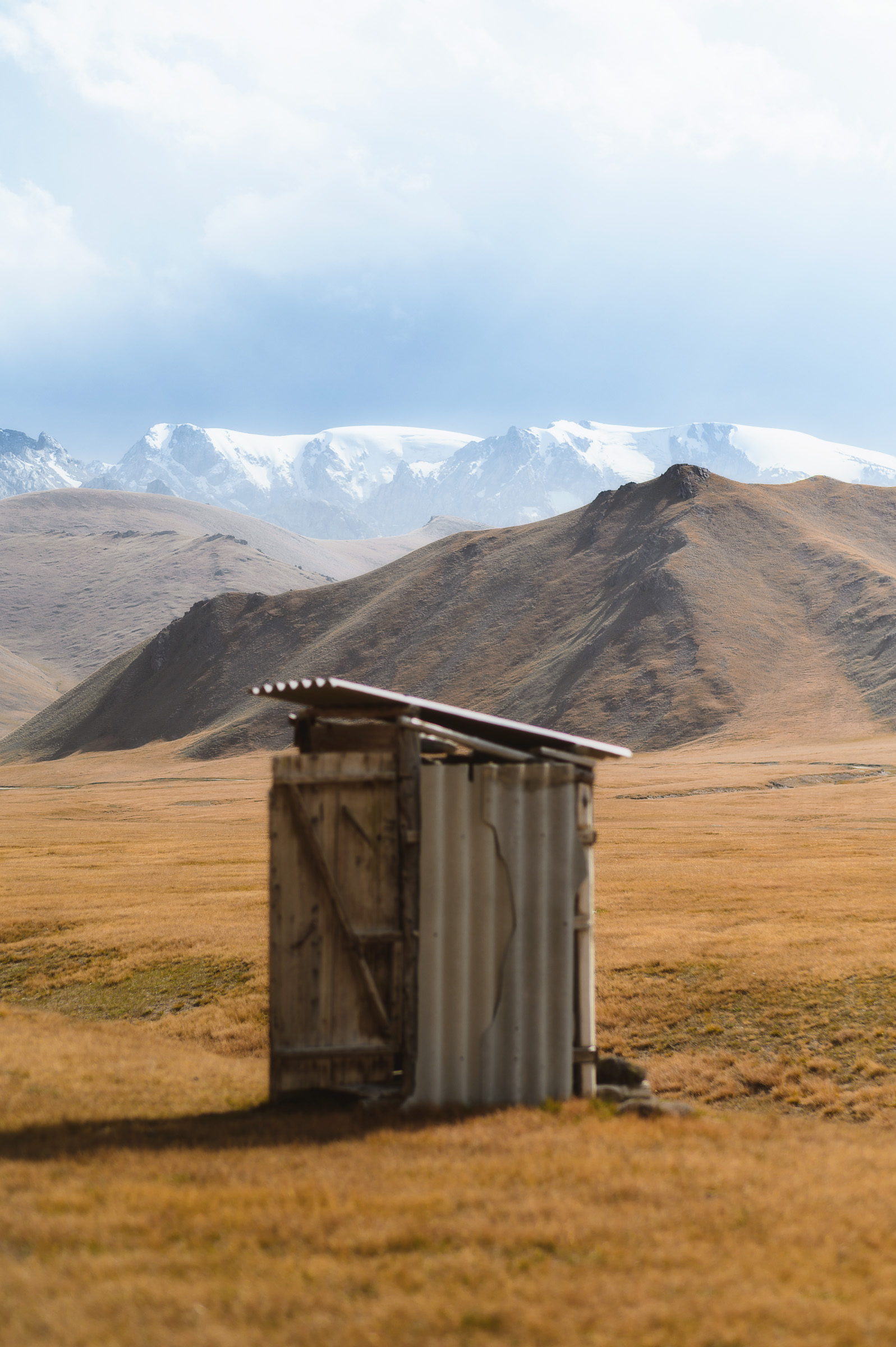 Simple wooden shelter standing alone on the steppe