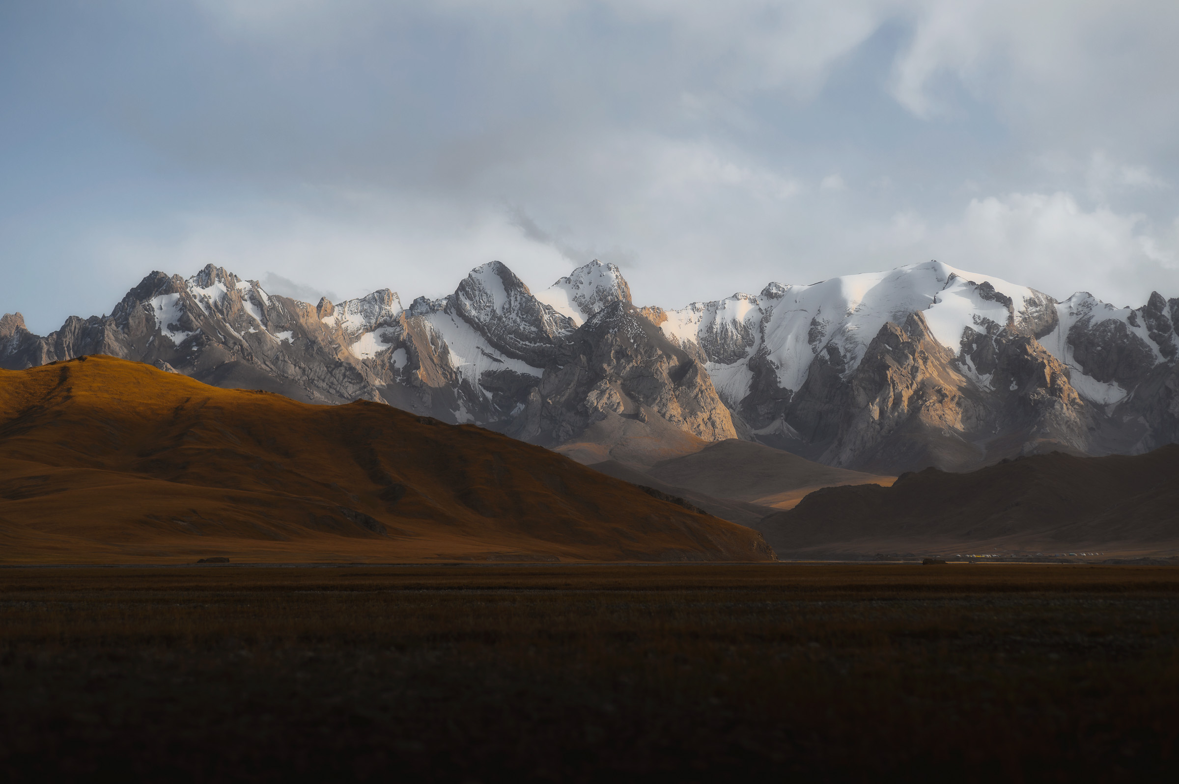 Jagged mountain peaks beneath dramatic storm clouds