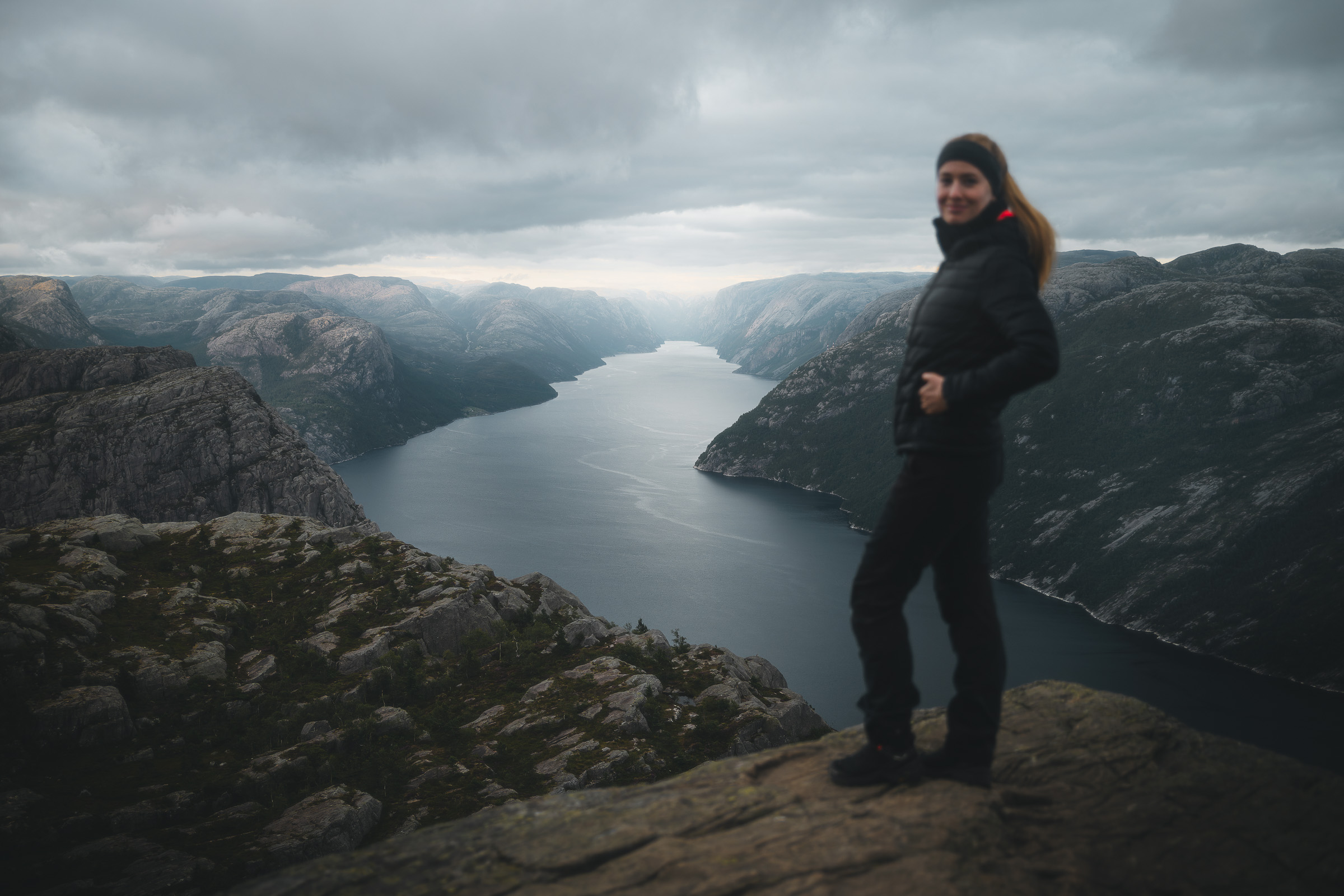 Woman hiker at a rocky viewpoint overlooking Lysefjord