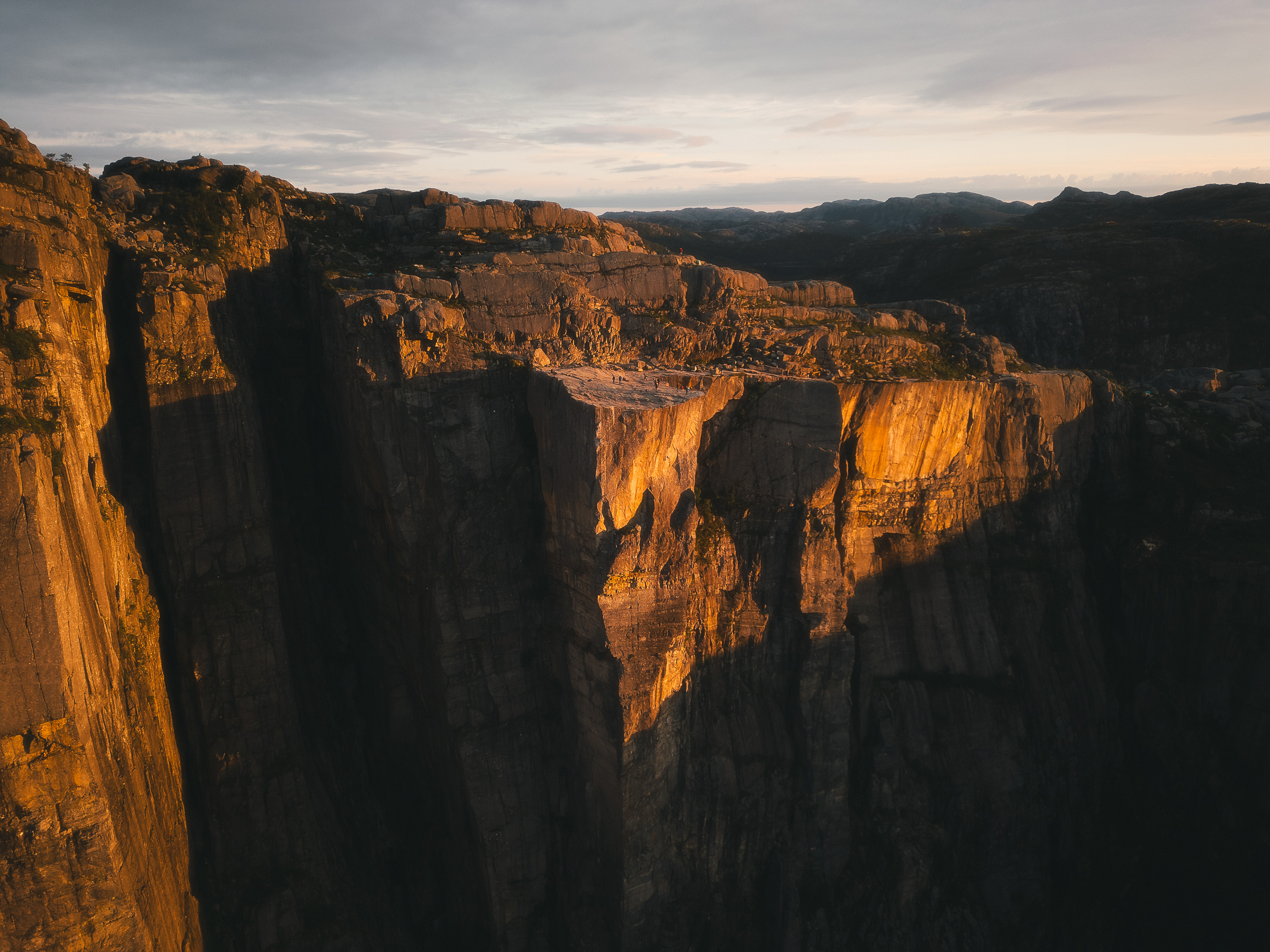 Golden sunrise light across the cliffs and plateau of Preikestolen