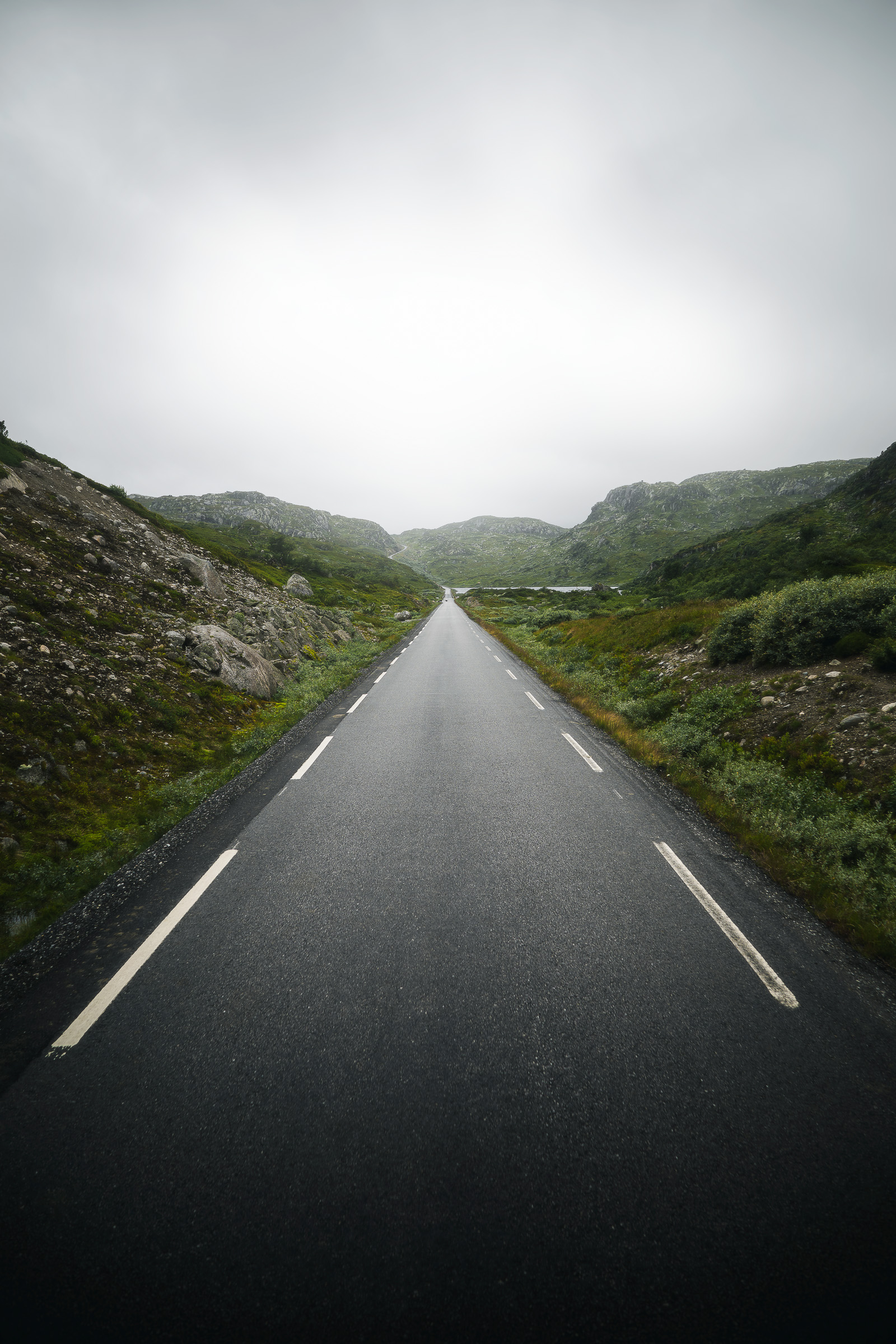 Empty road leading through misty mountains in Southern Norway