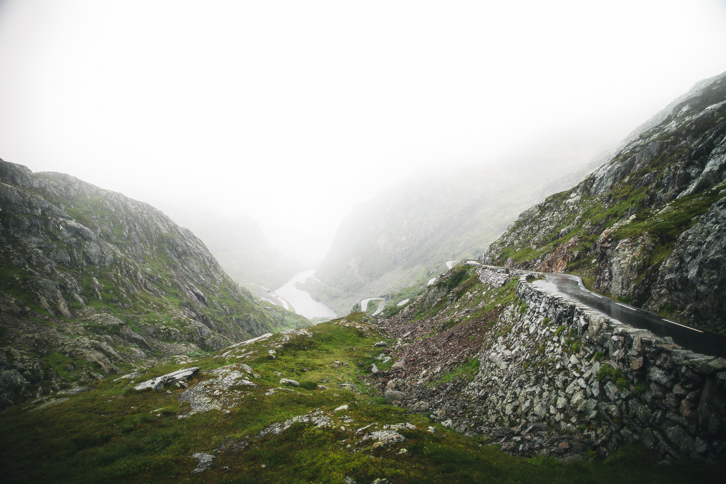 Fog settling over a narrow road through the Norwegian highlands