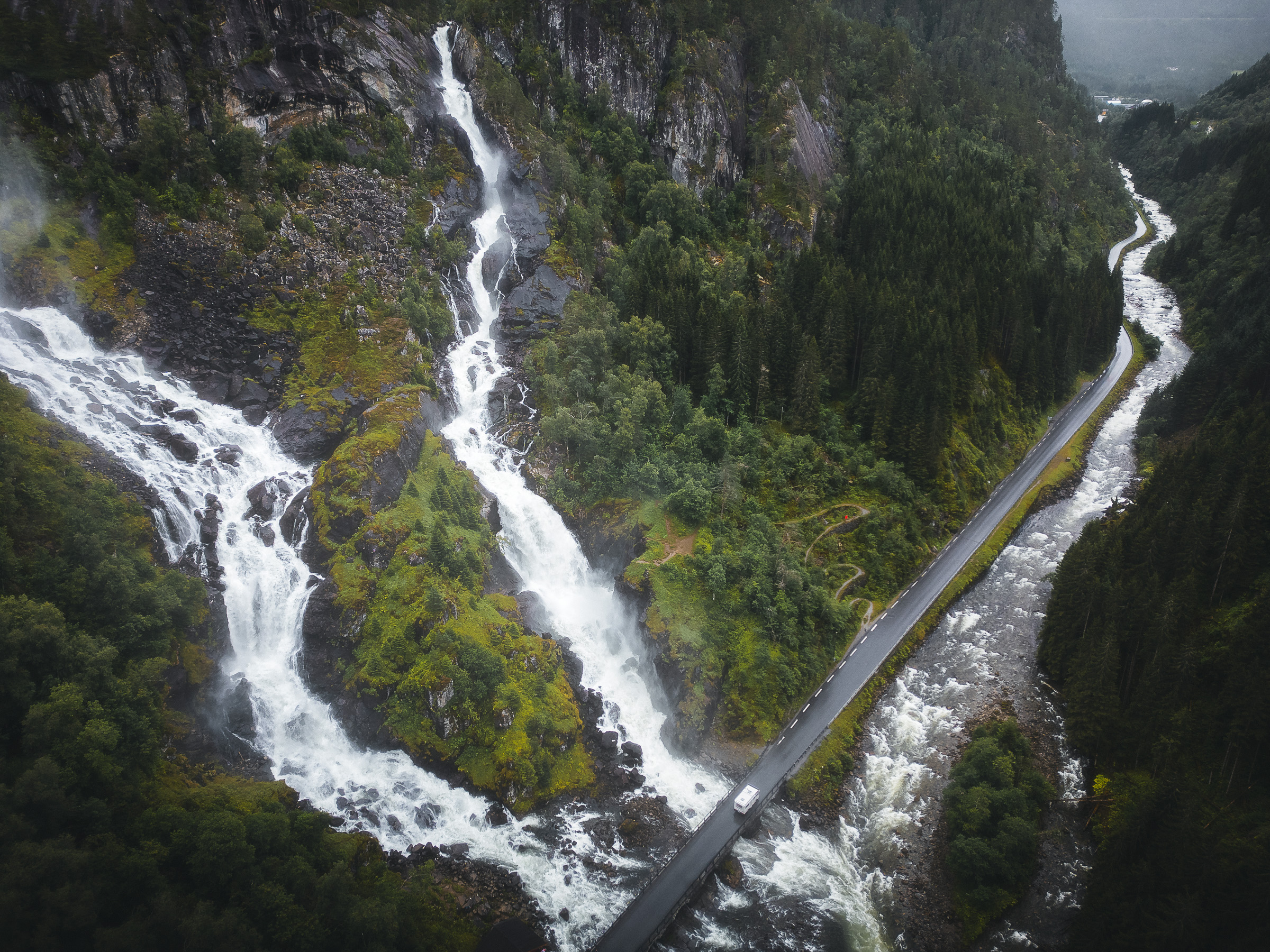 Aerial view of waterfalls crossing a mountain road