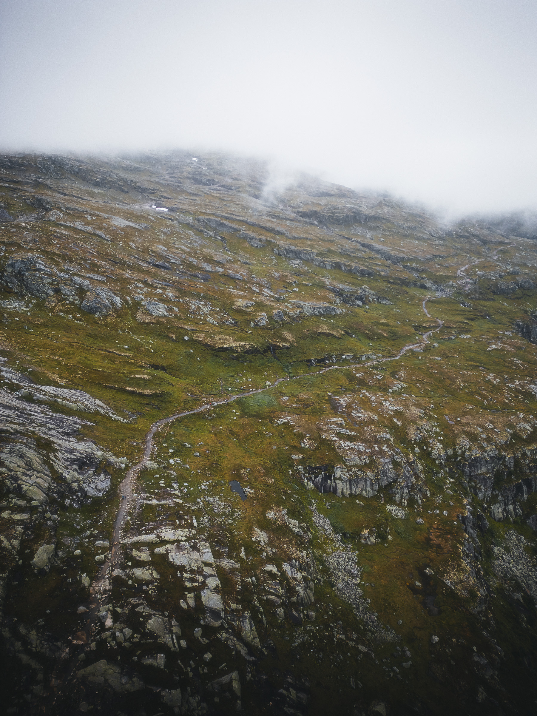 Hiking trail zigzagging across a rocky mountain slope