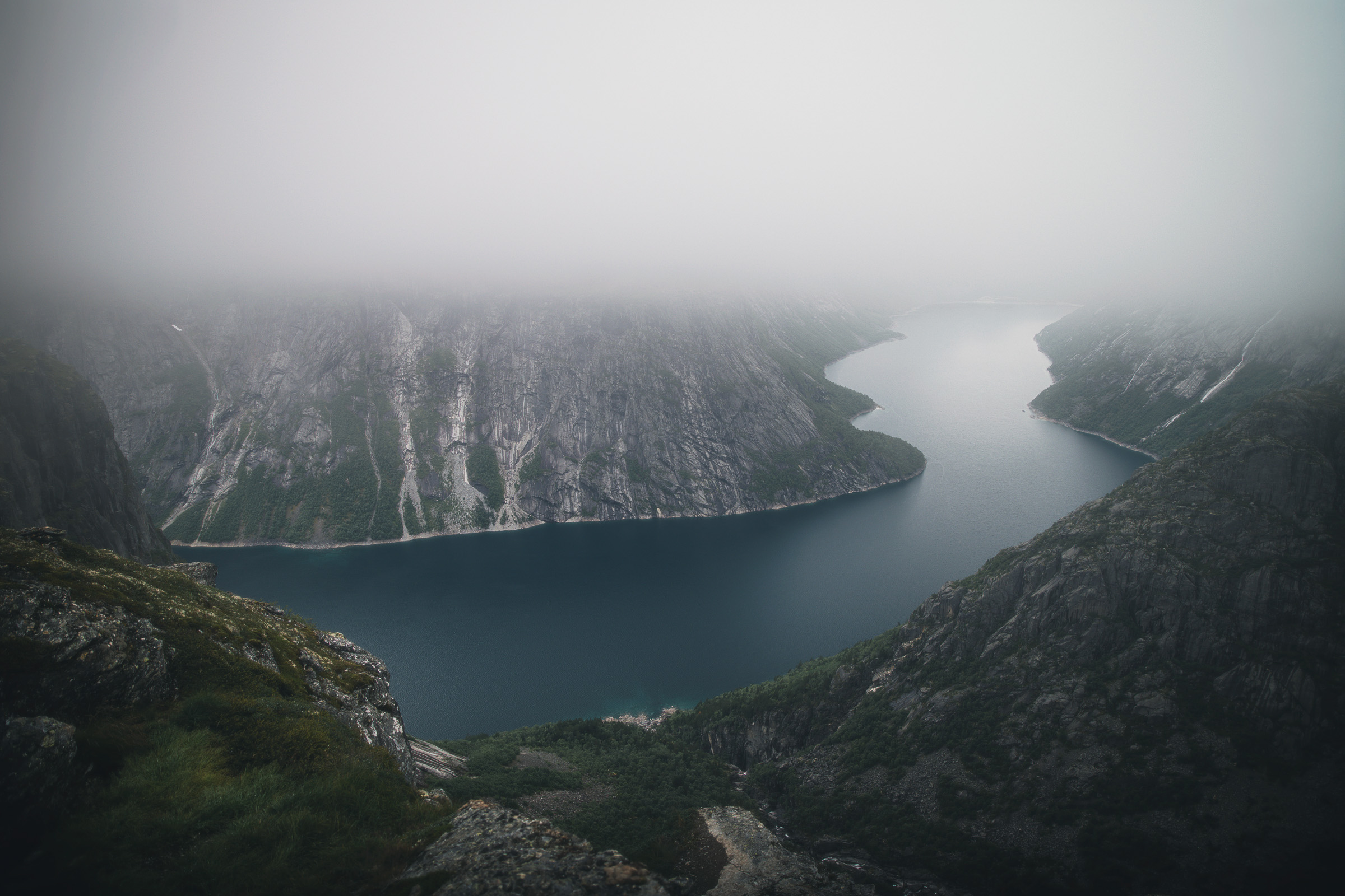 Ringedalsvatnet curving between cliffs covered in fog