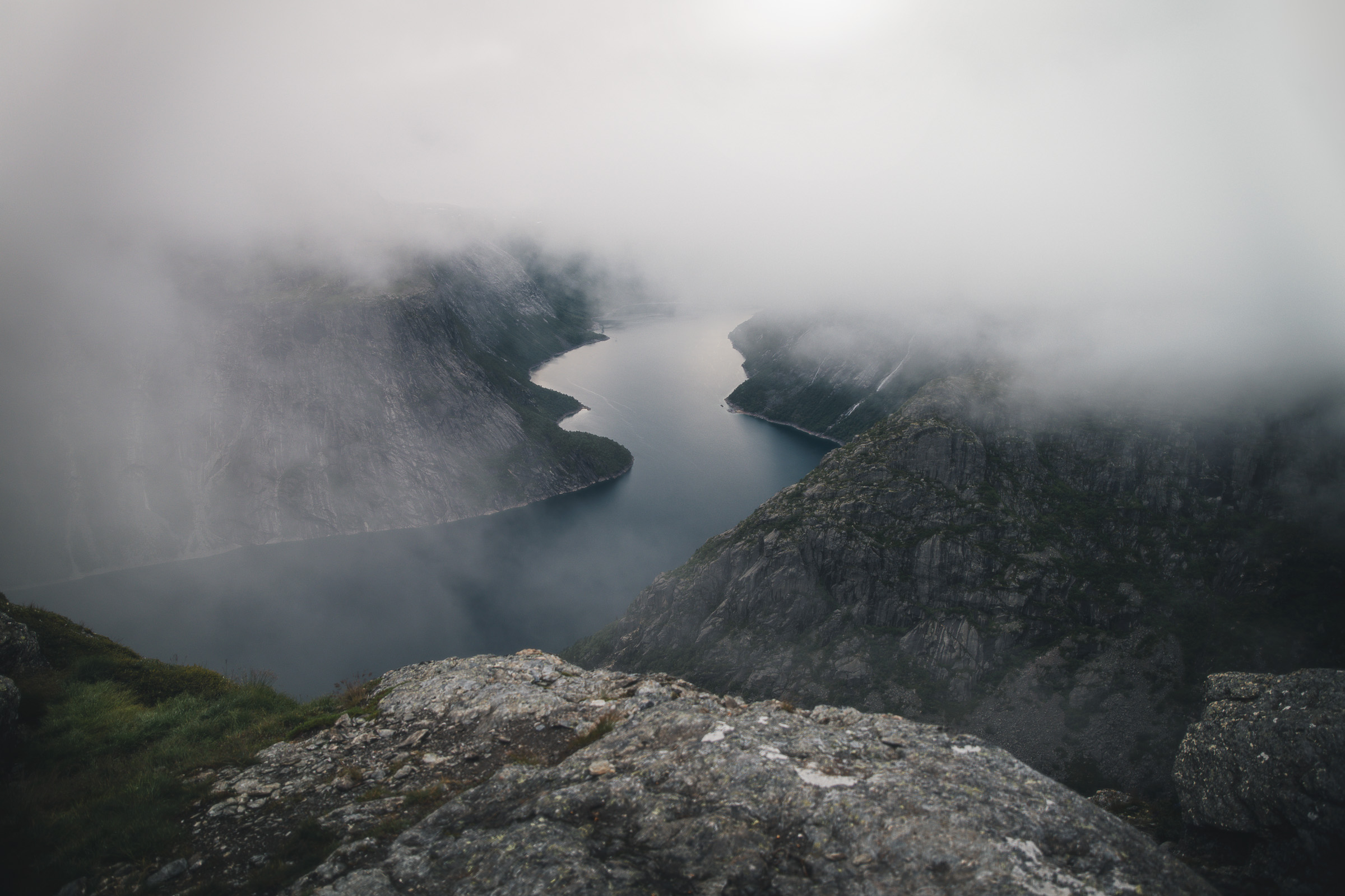 Fog drifting over Ringedalsvatnet below a rocky viewpoint