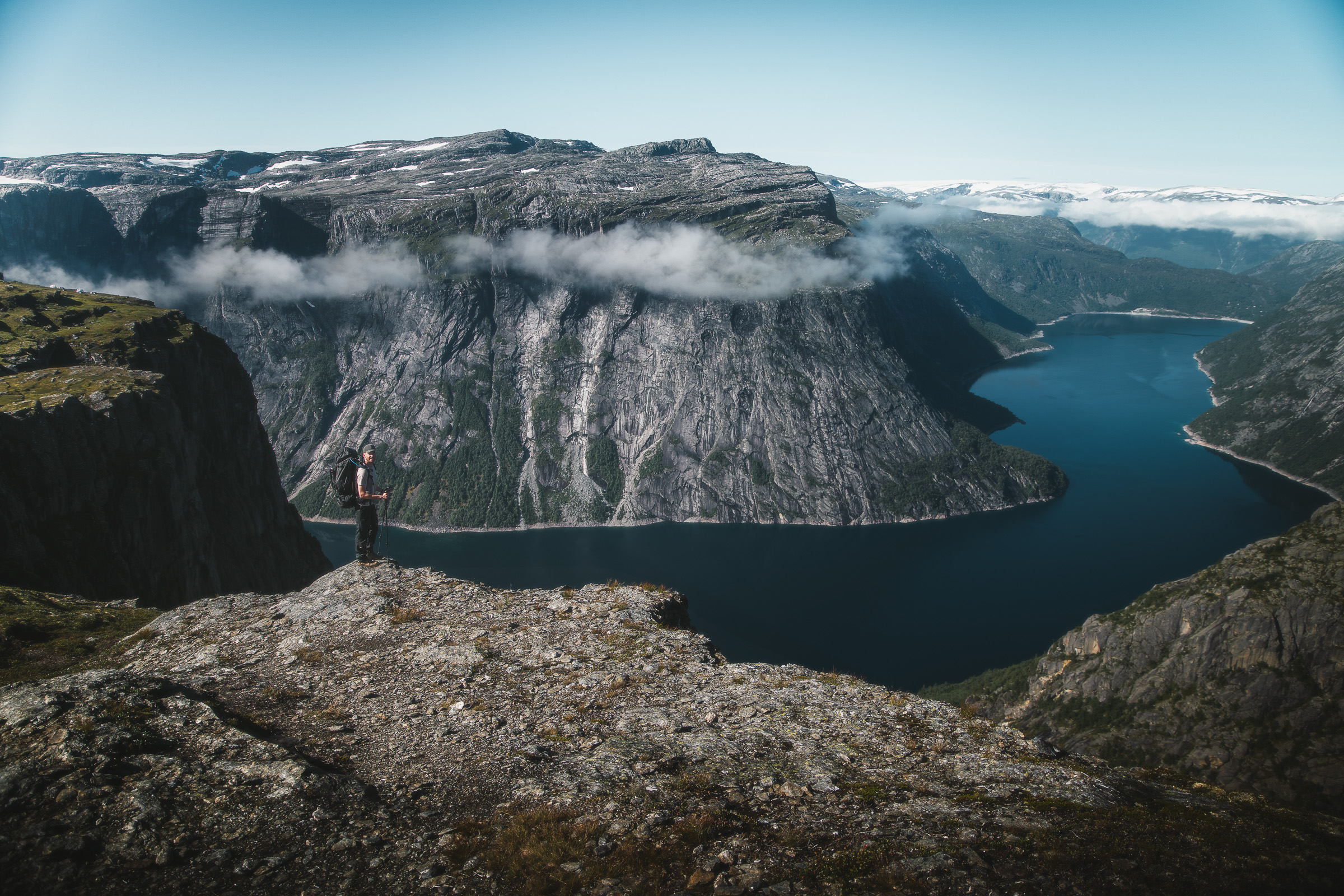 Wide view of Ringedalsvatnet and cliffs beneath lifting clouds