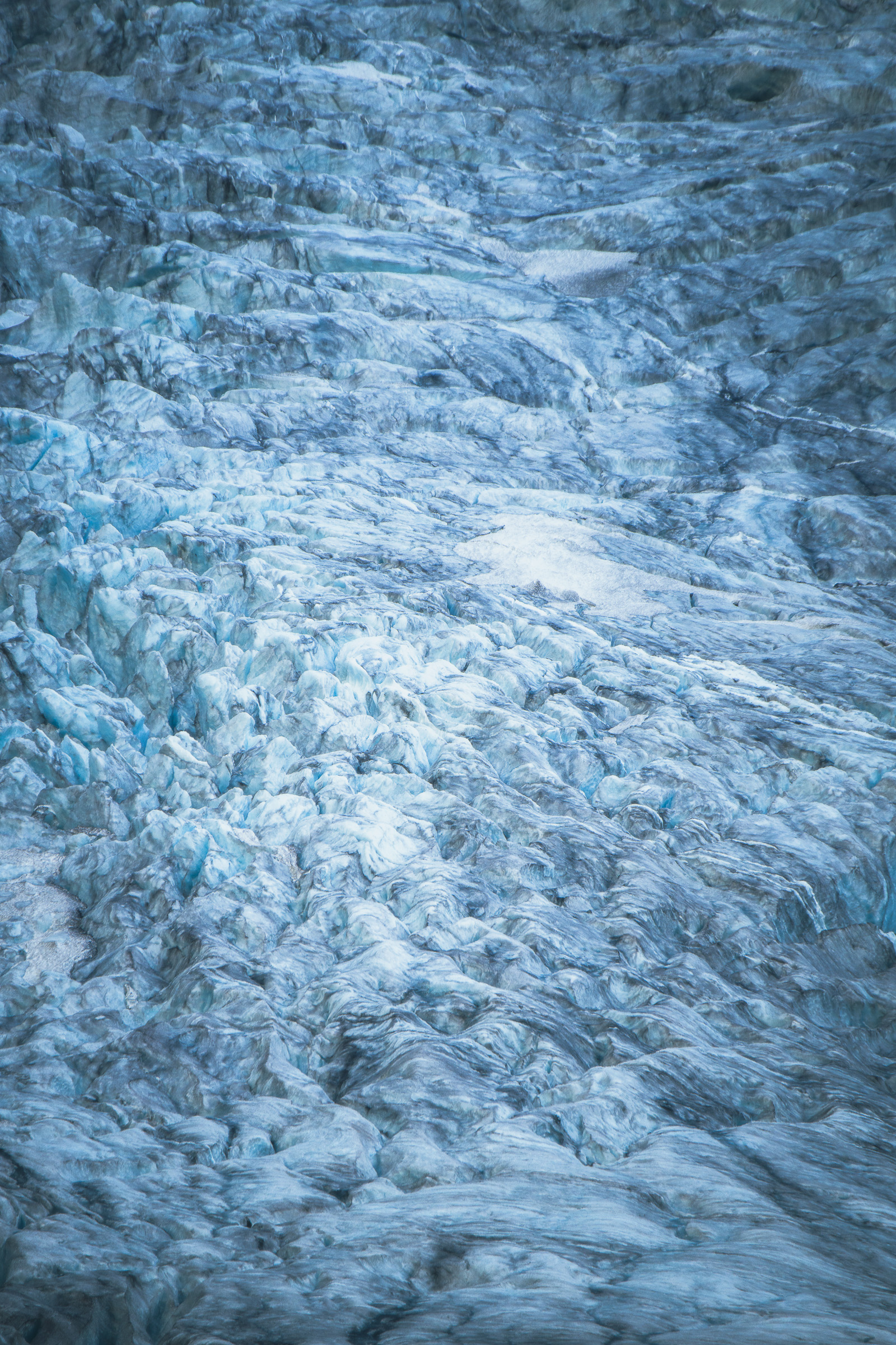 Close-up of cracked blue glacial ice