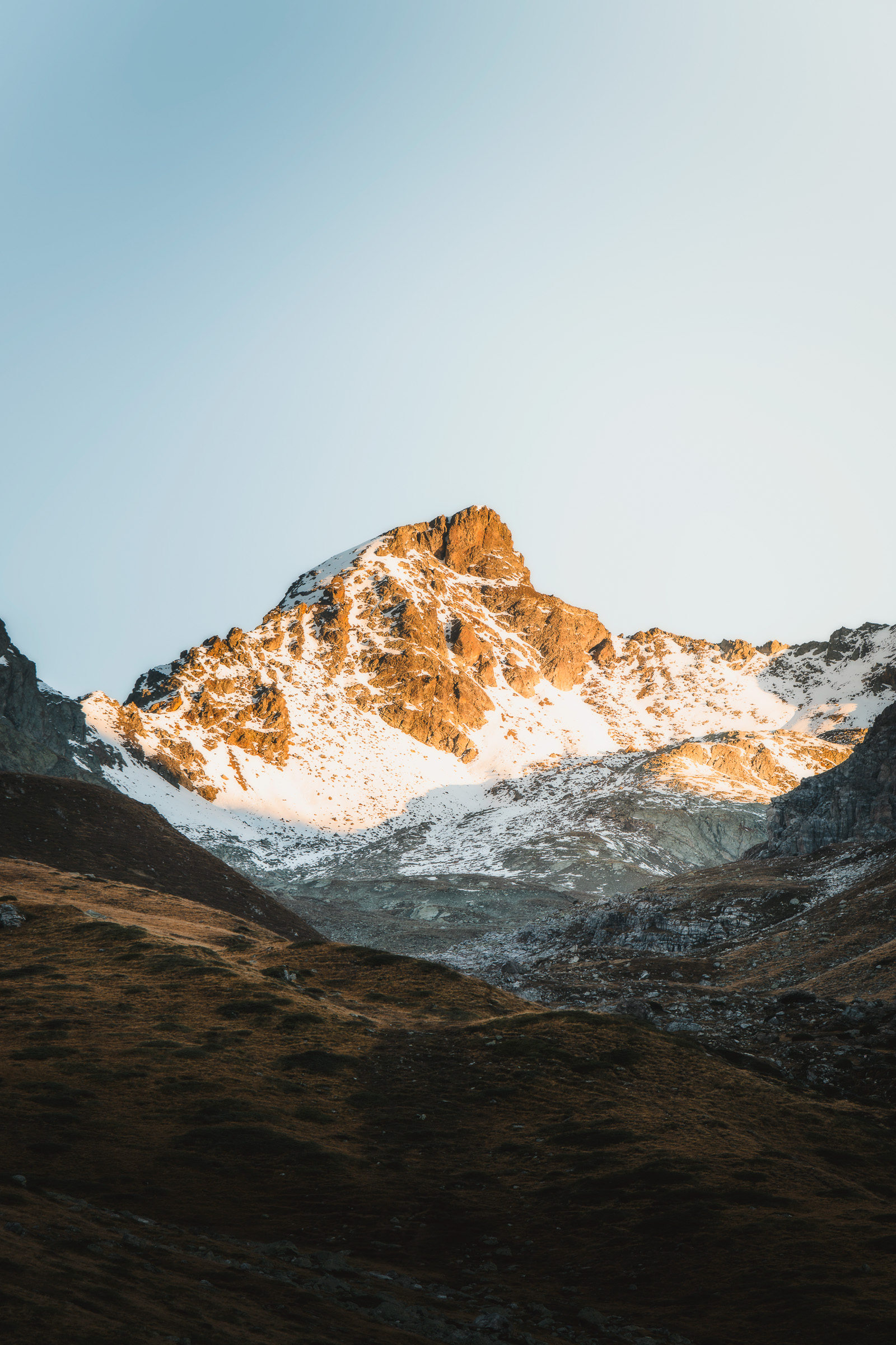 Snow-covered mountain peak glowing in morning light
