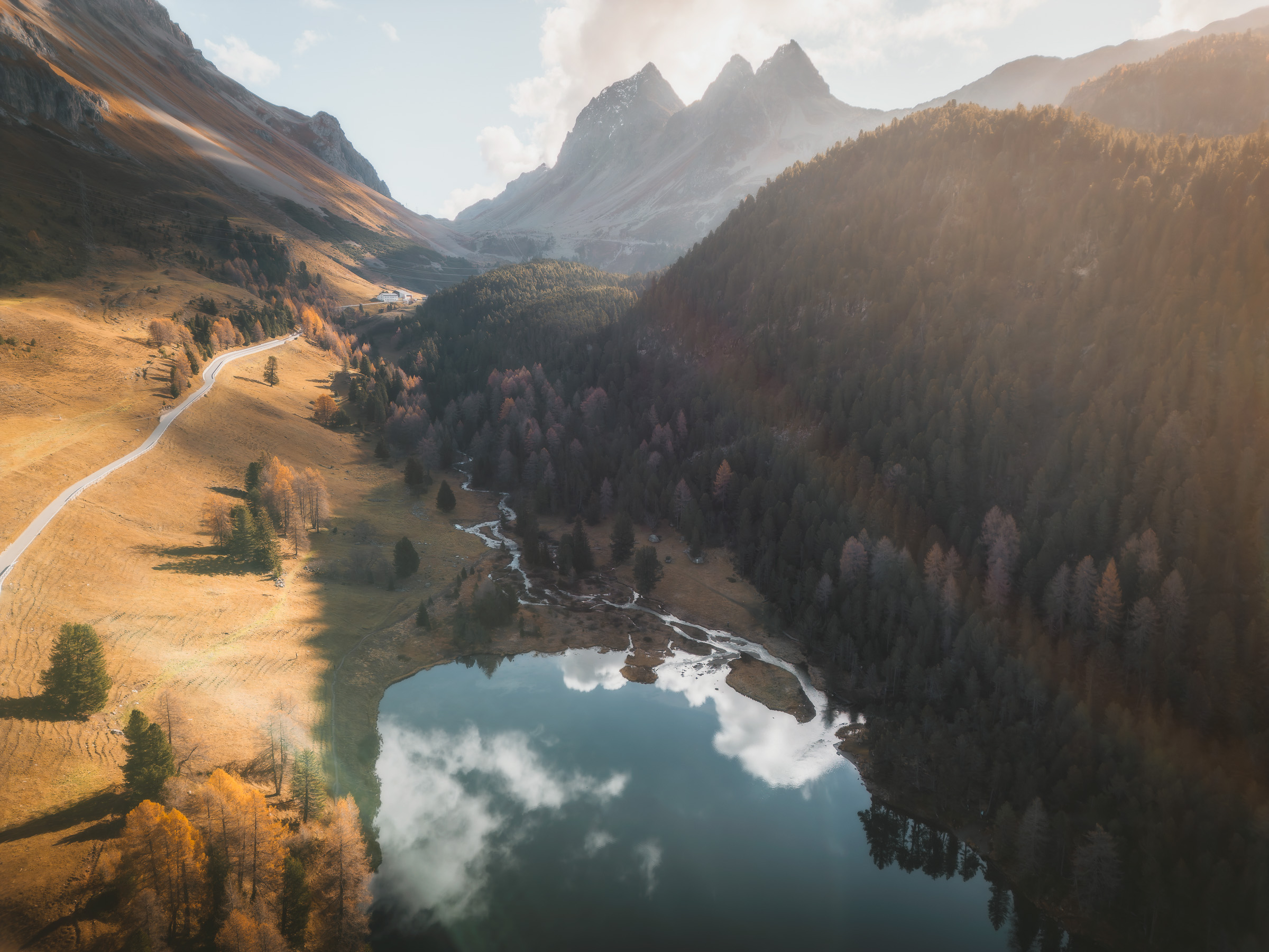 Aerial view of a small mountain lake and autumn valley