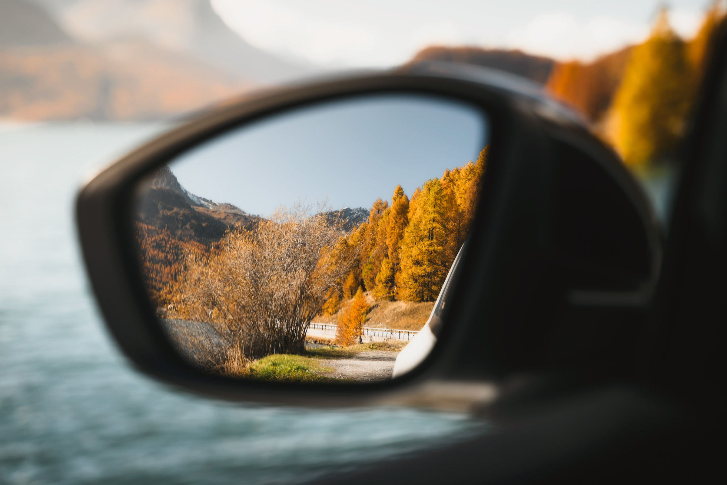 Autumn mountain landscape reflected in a car side mirror