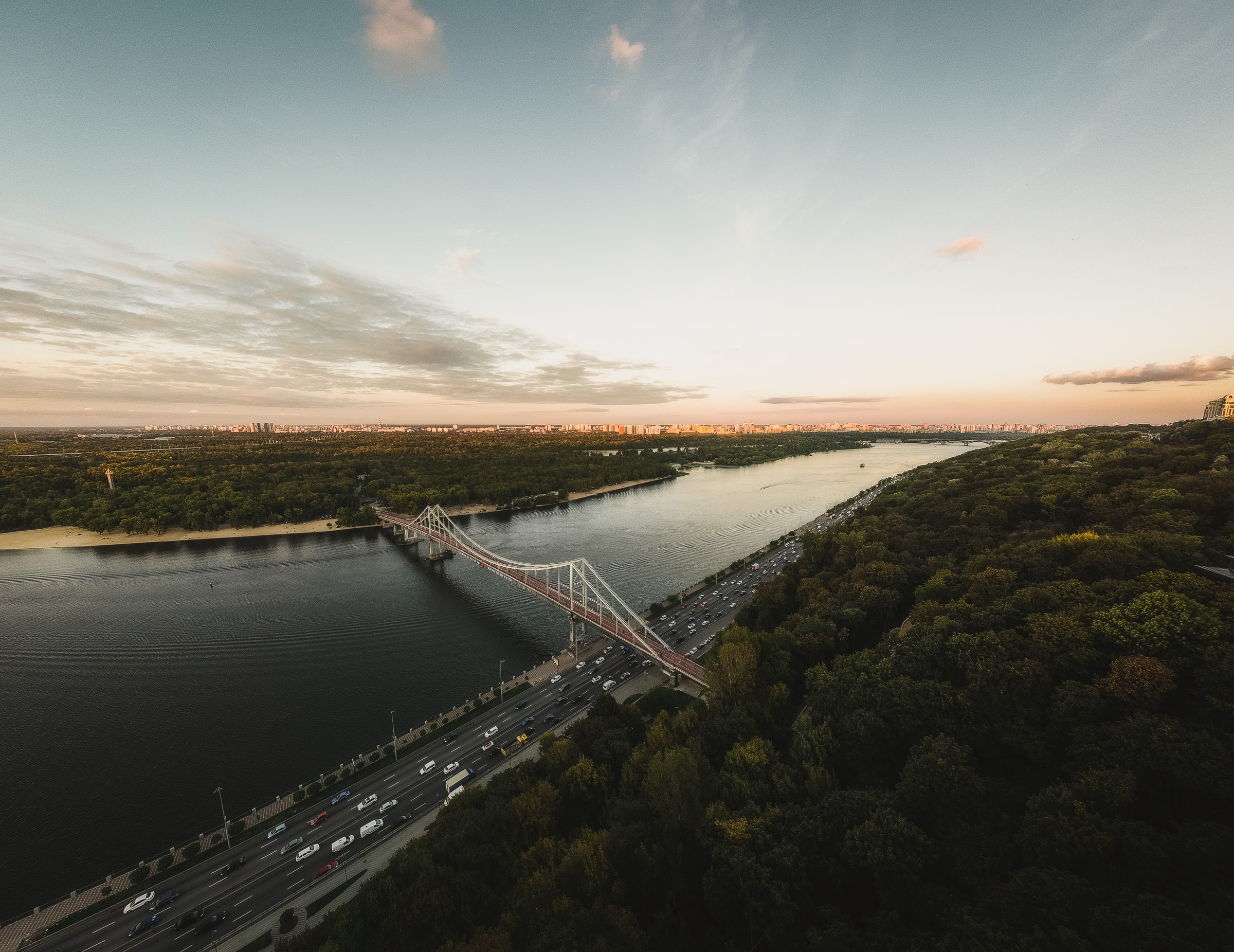 Aerial view of a road and bridge along the Dnipro at sunset