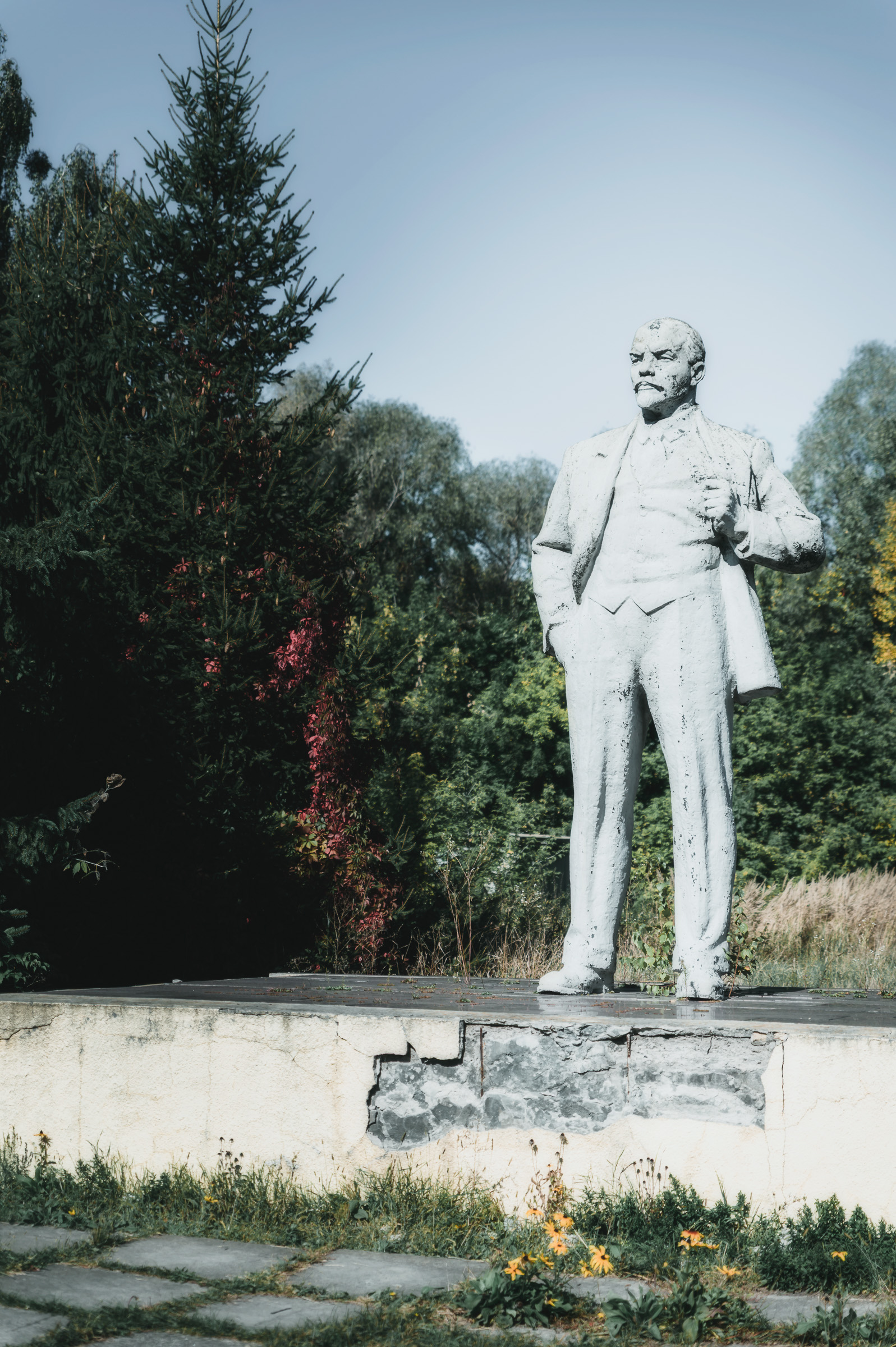 Soviet-era statue surrounded by trees in Chernobyl