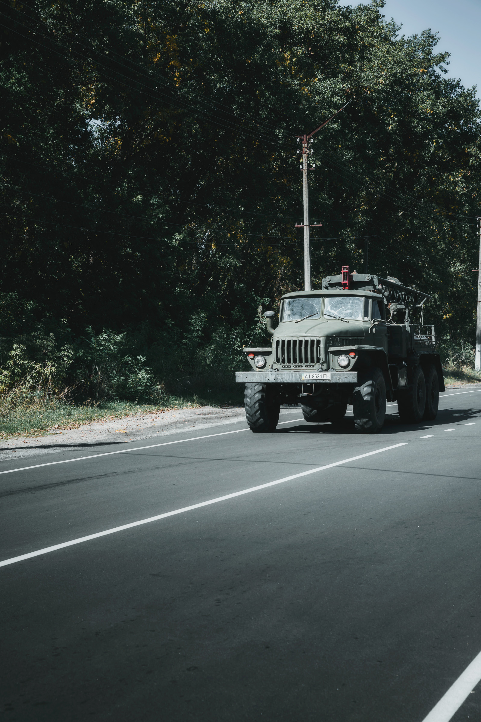 Armored patrol vehicle traveling along a forest road