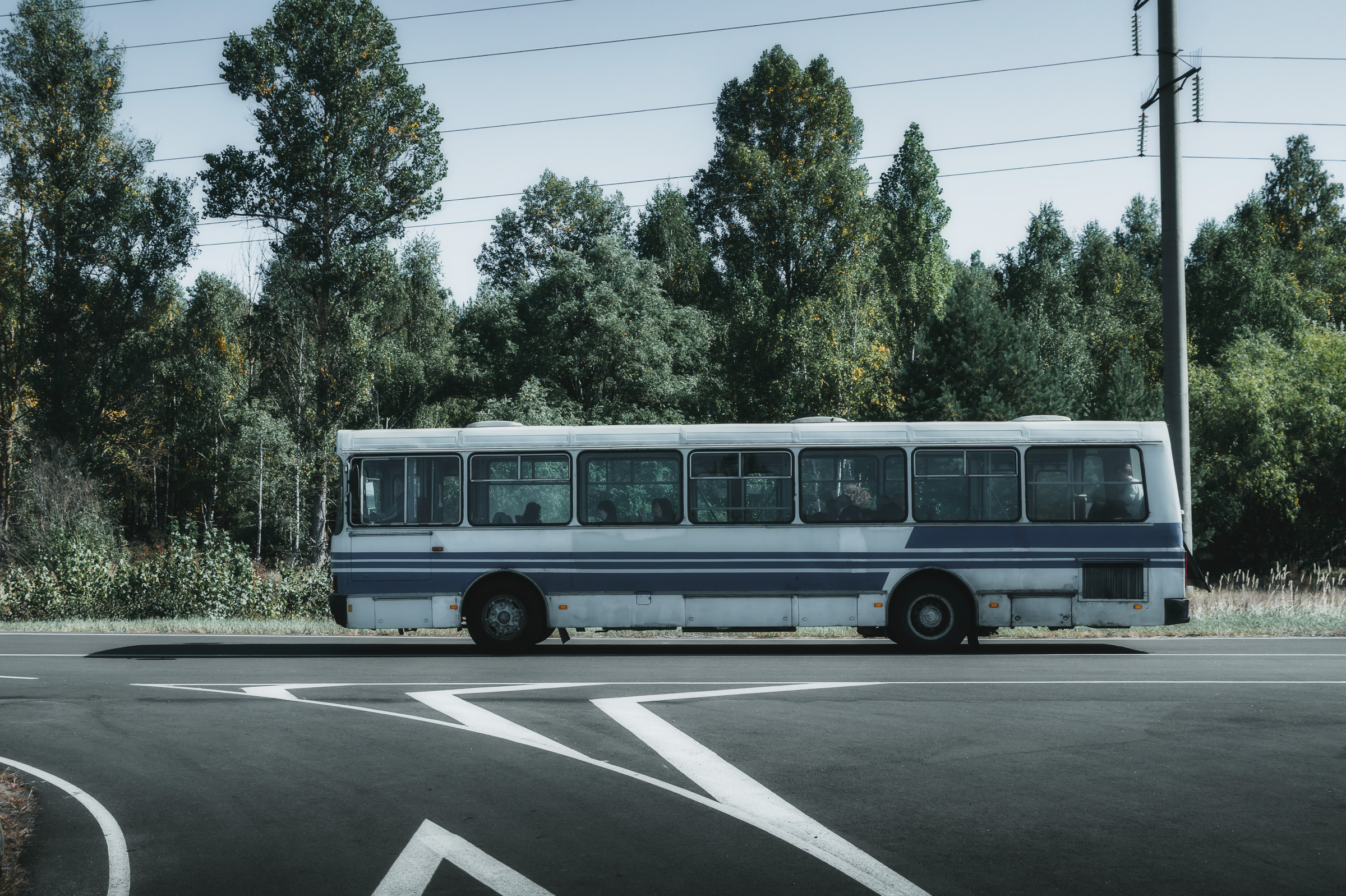 Old bus waiting at an empty road junction