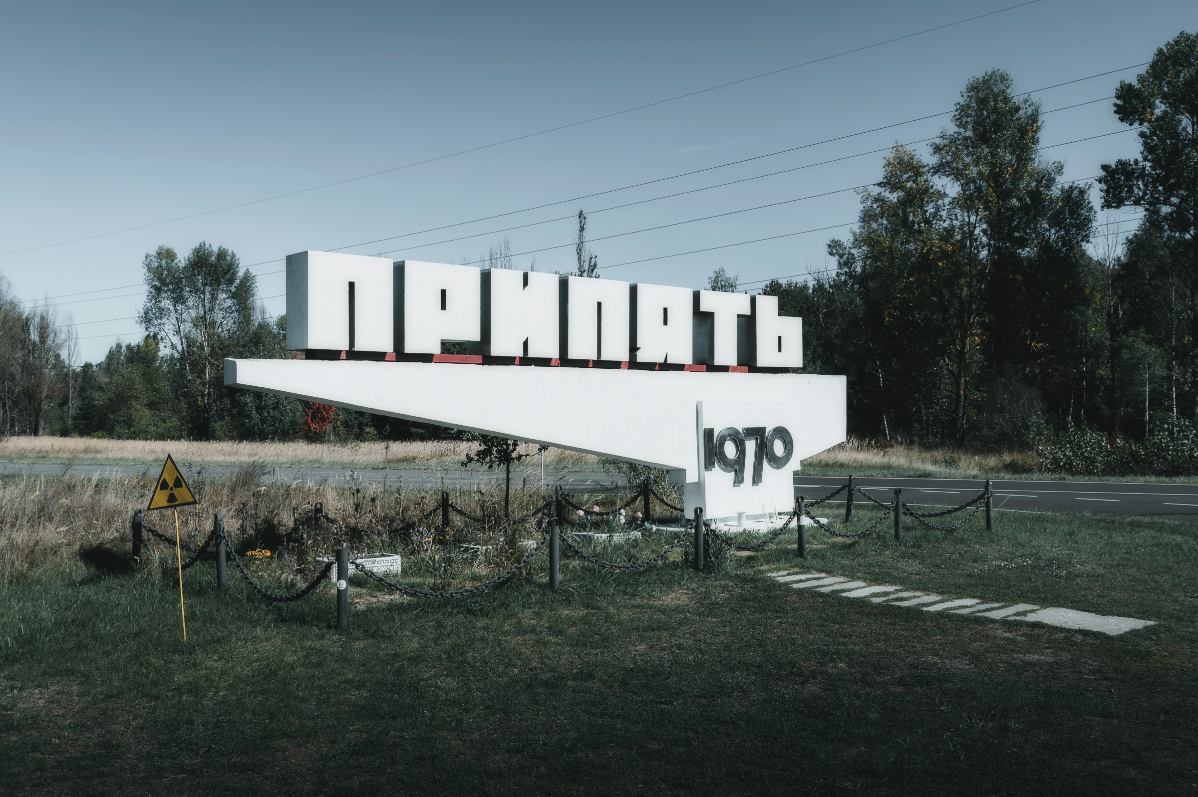Pripyat 1970 entrance sign beside an empty road