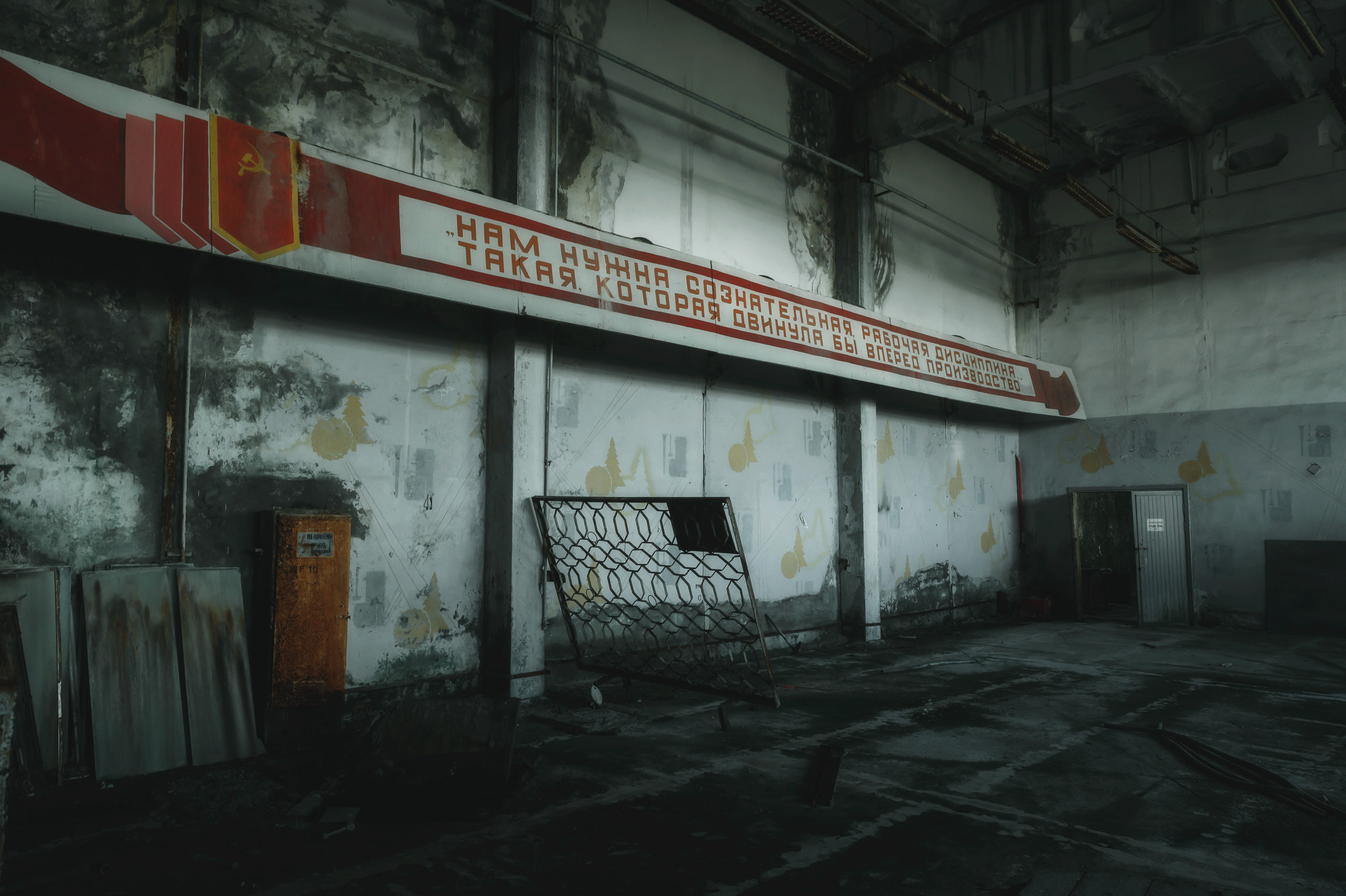 Deserted gymnasium with faded Soviet signage