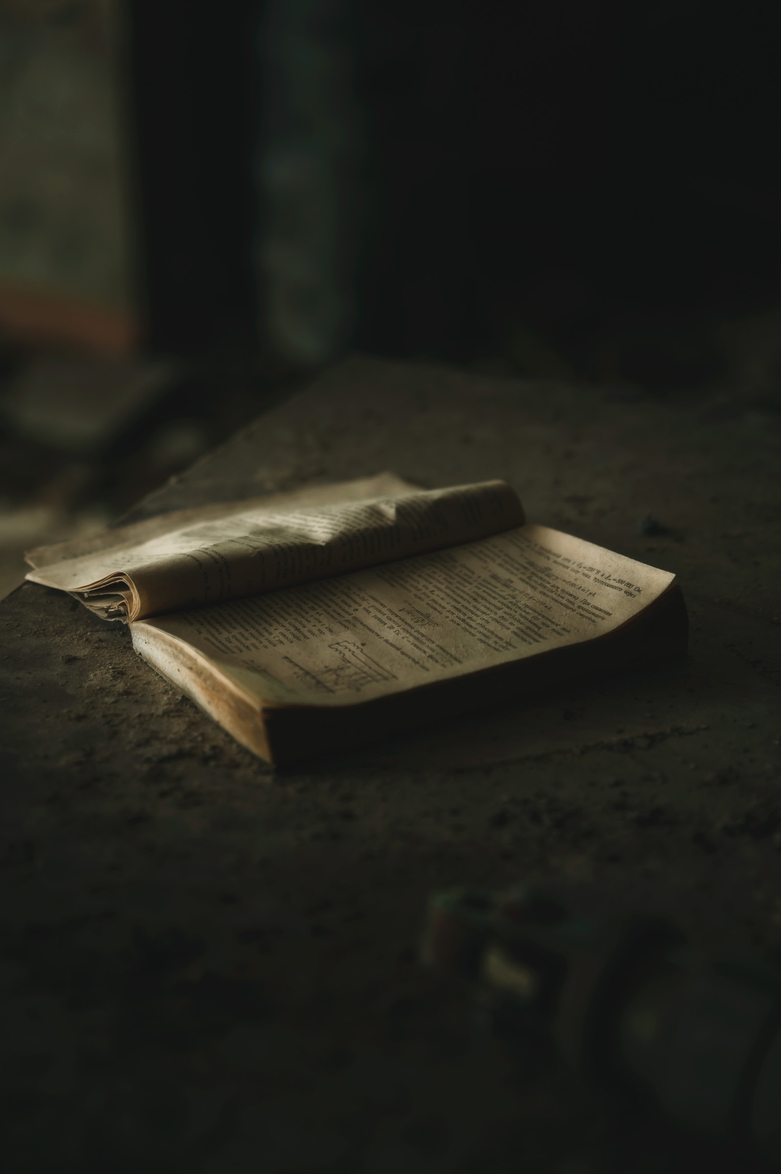 Open book resting on a dusty surface in Pripyat
