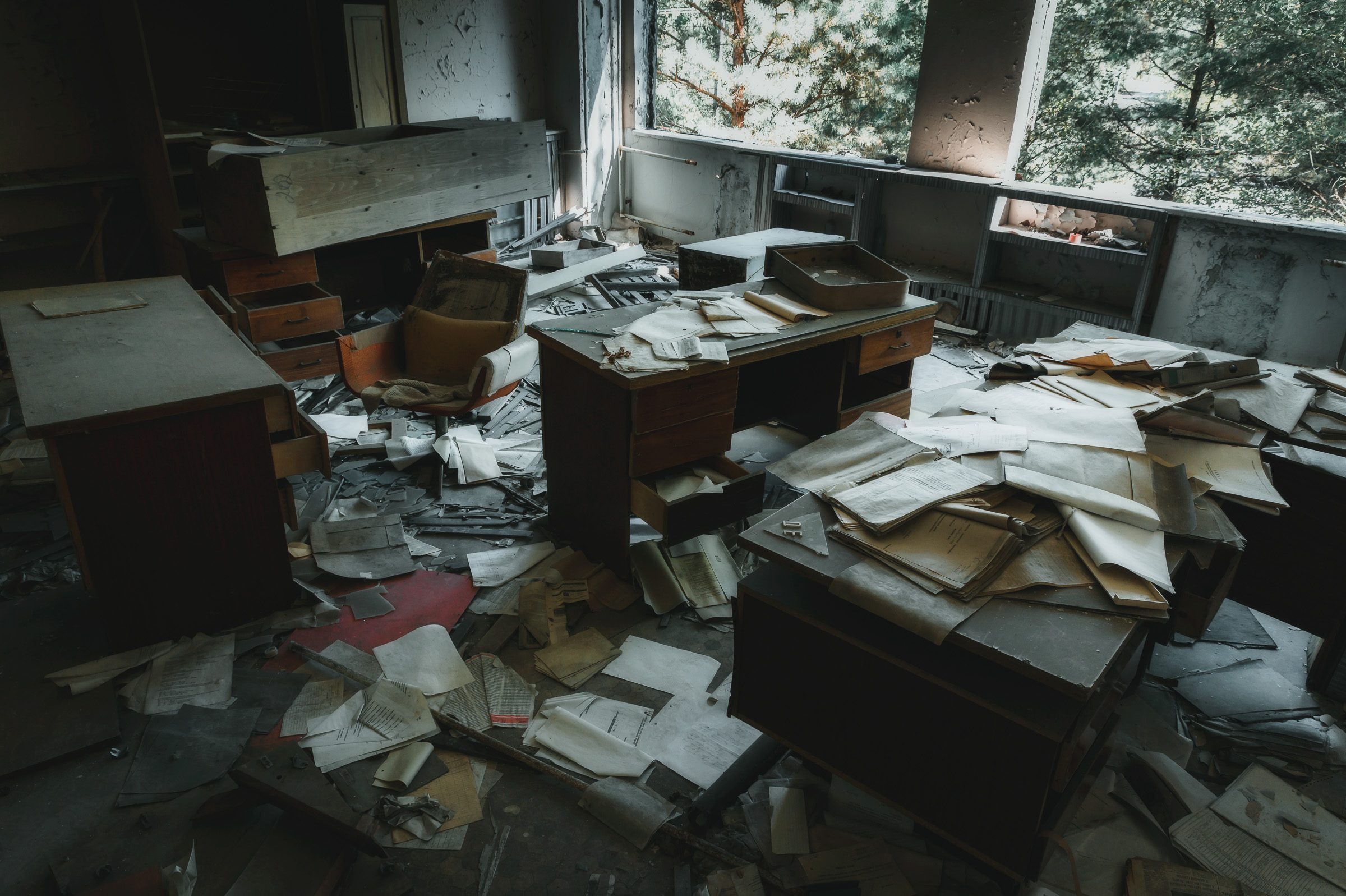 Papers scattered across desks in an abandoned office