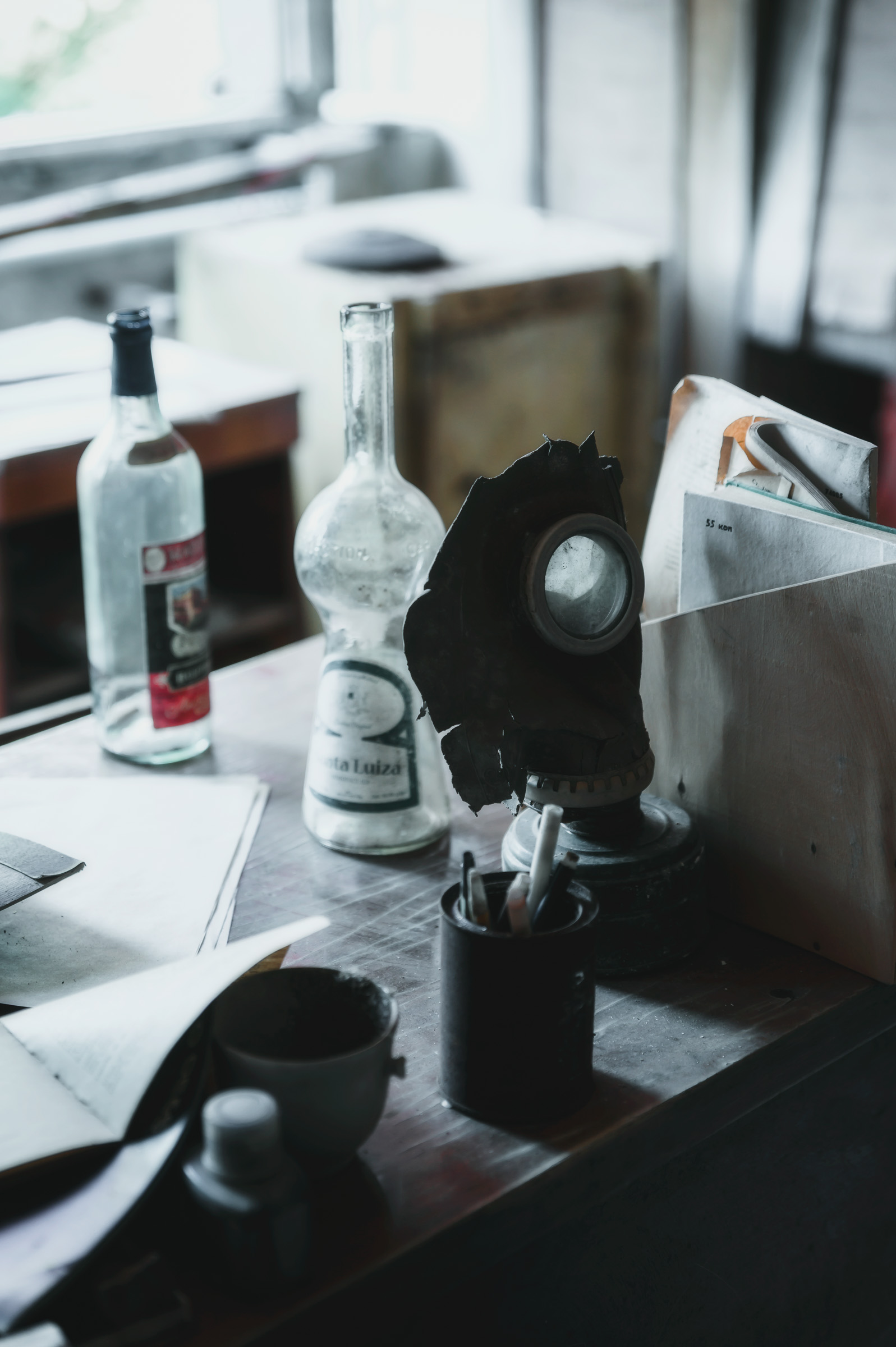 Bottles and personal items left on a neglected desk