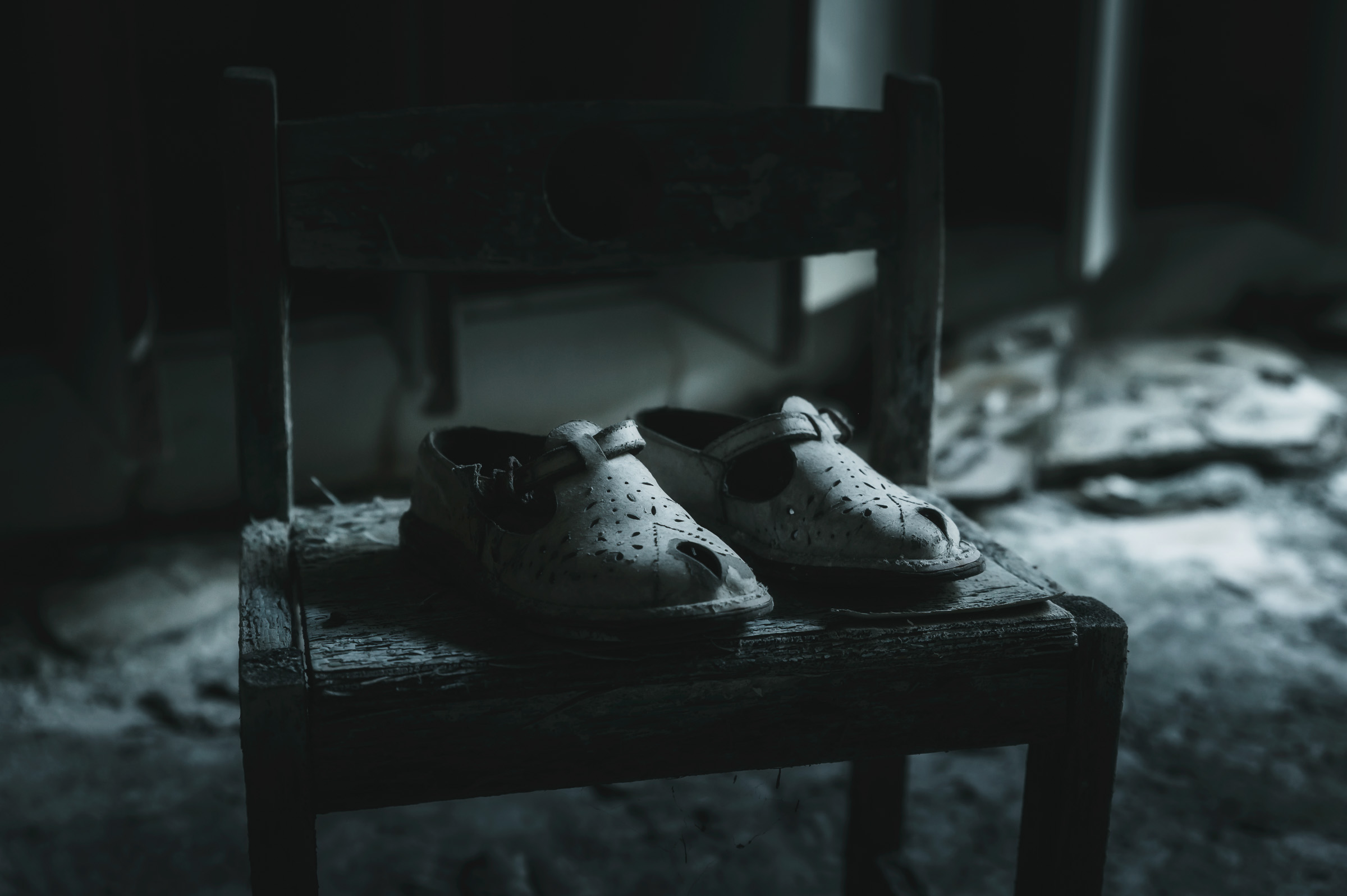 Pair of children's shoes left on a wooden stool