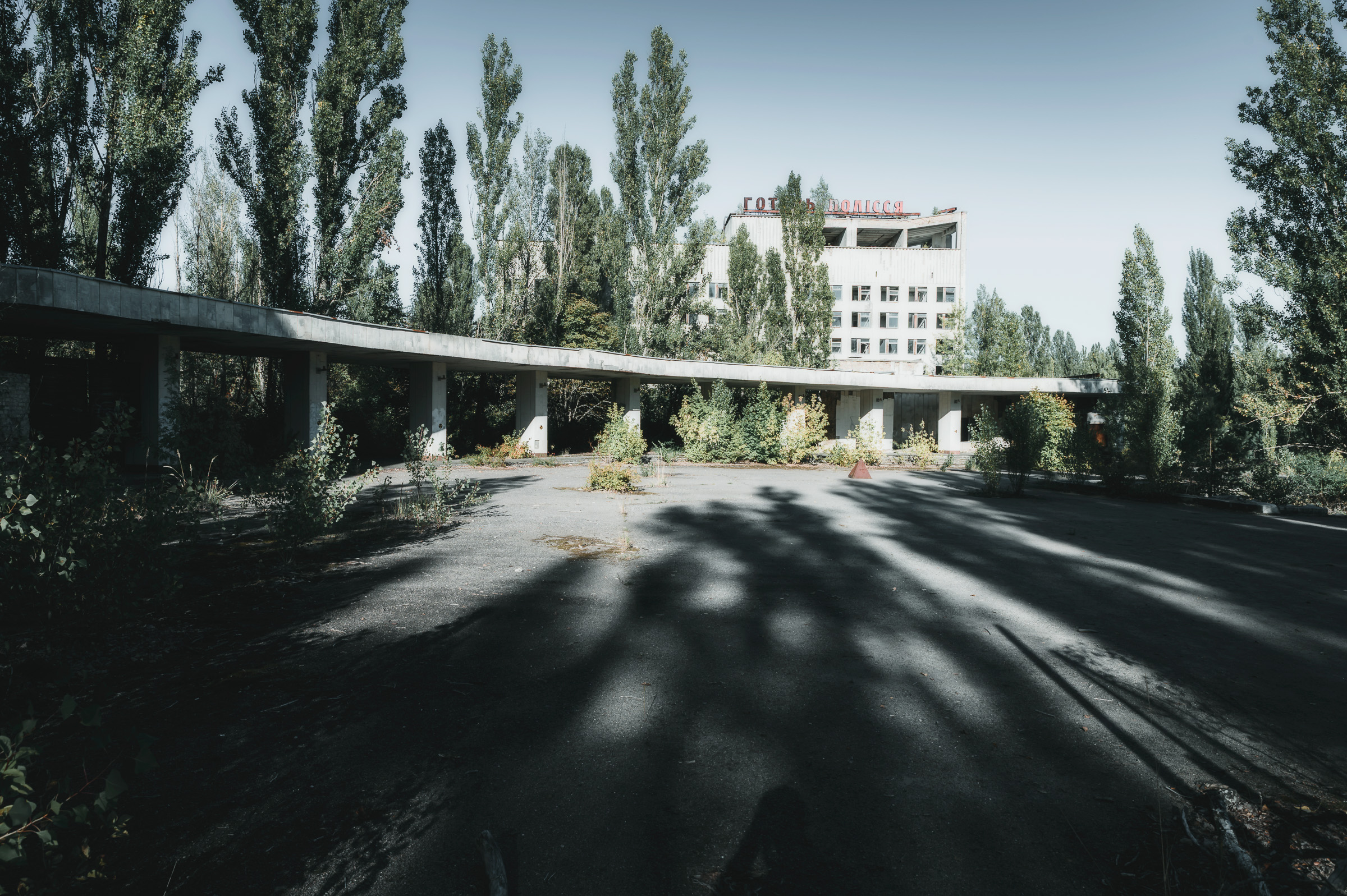 Empty avenue and pedestrian bridge in central Pripyat