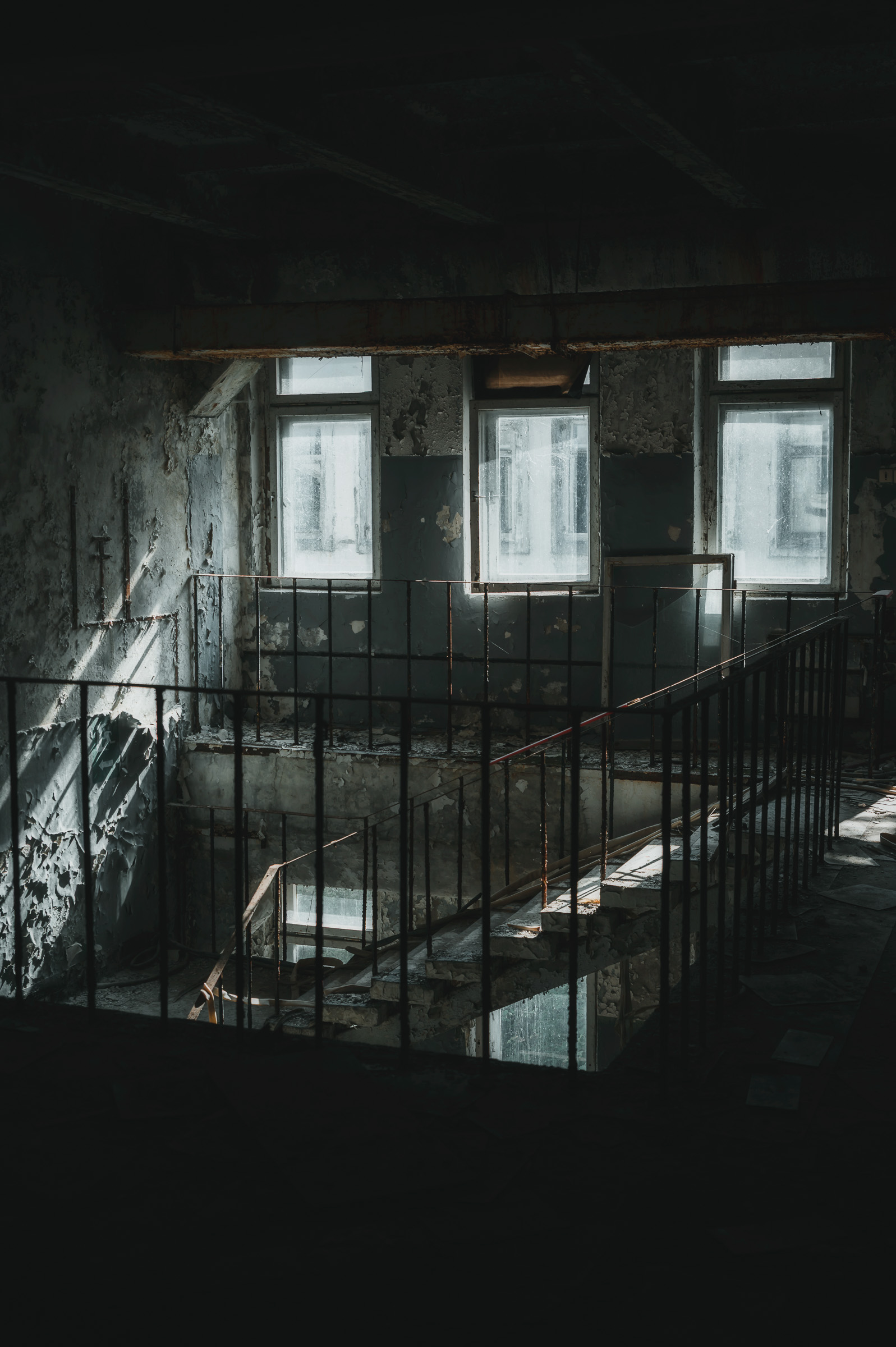 Empty decaying stairwell inside an abandoned building