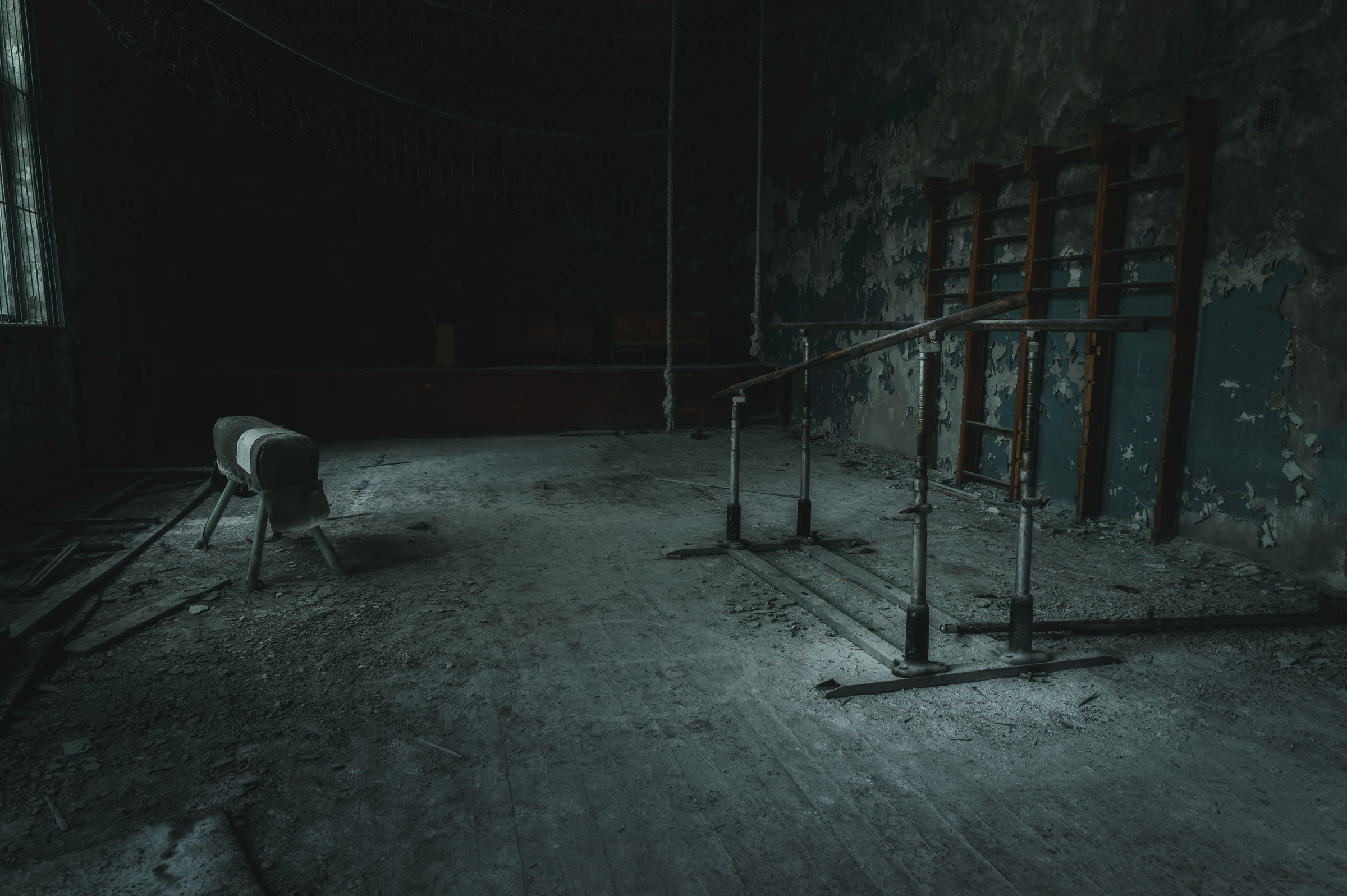 Abandoned gym floor with chairs and exercise equipment